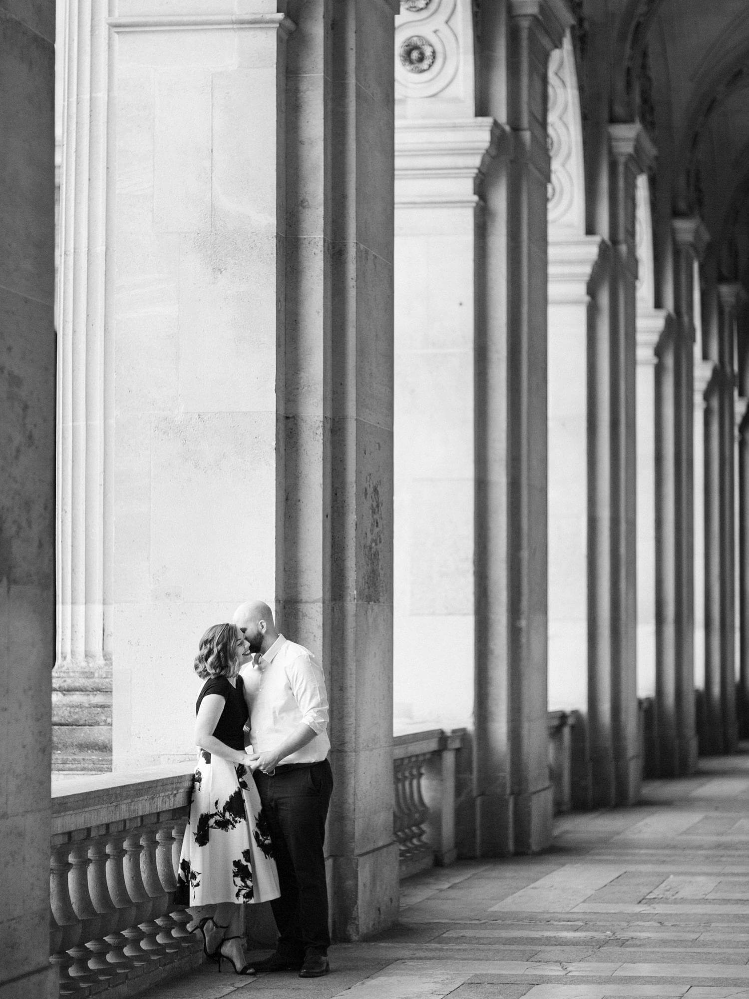 Couple embracing in hallway of Louvre Museum