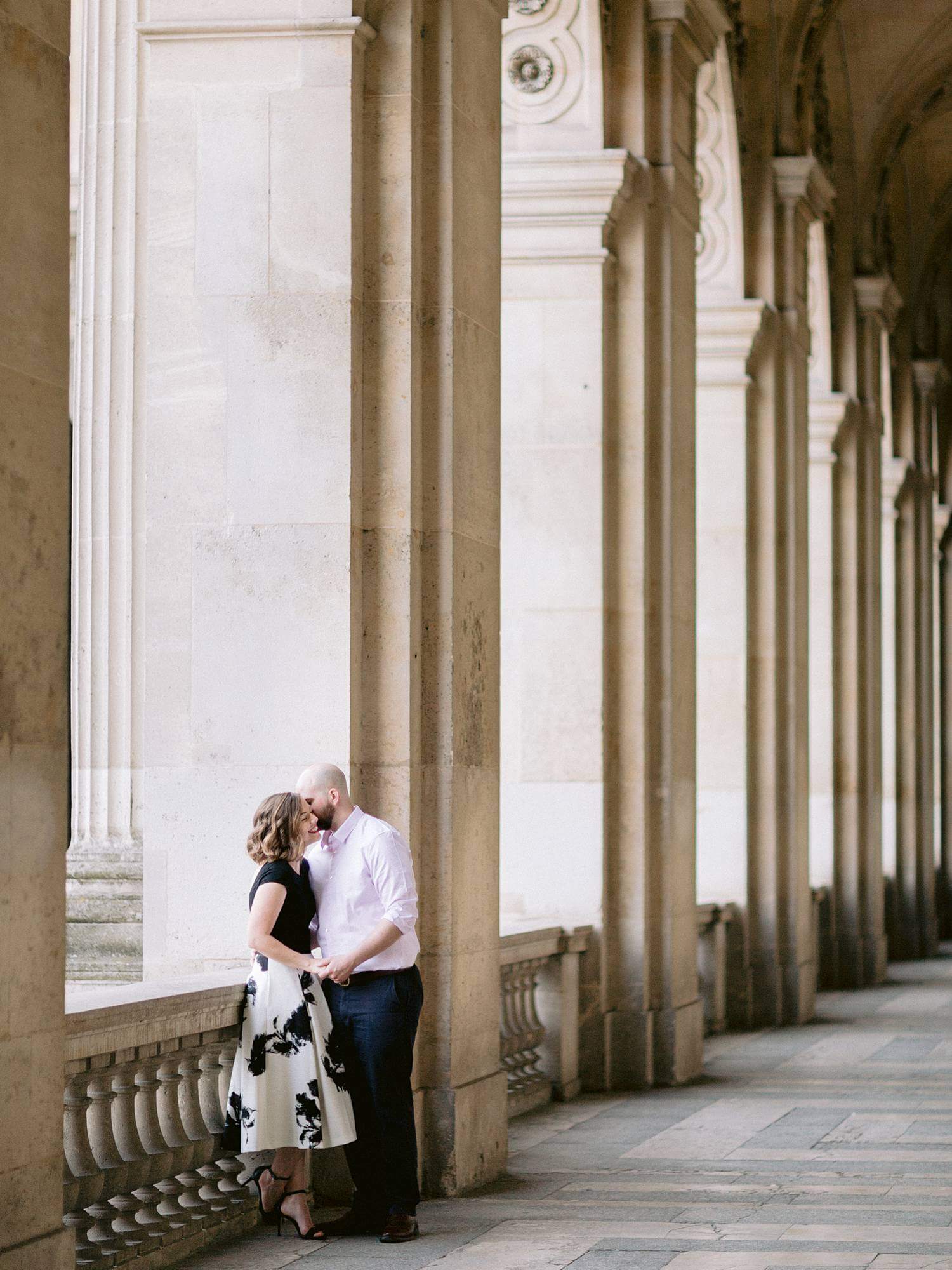 Couple embracing in hallway of Louvre Museum