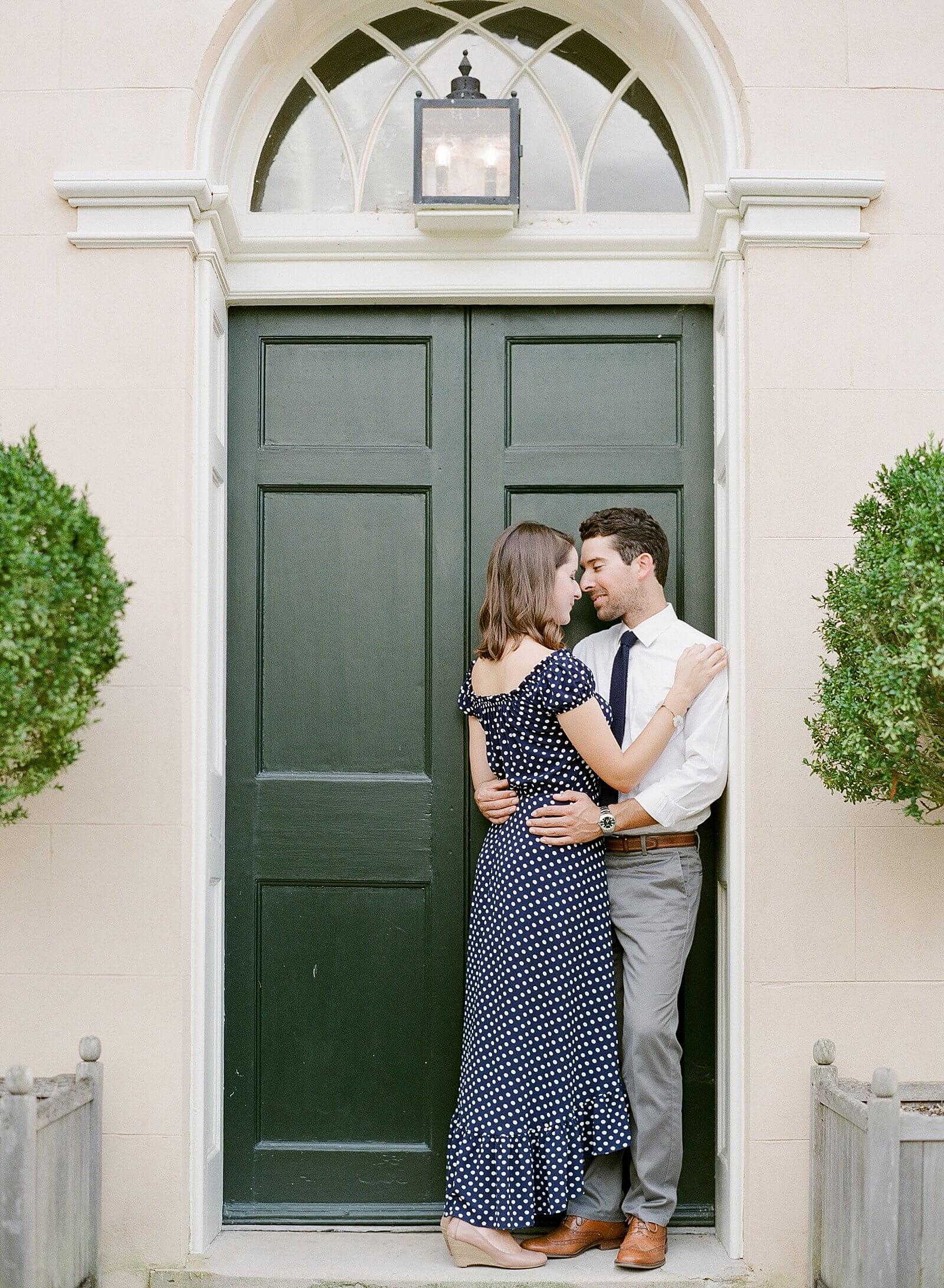 Bride and groom embracing in a doorway of Tudor Place during their engagement session