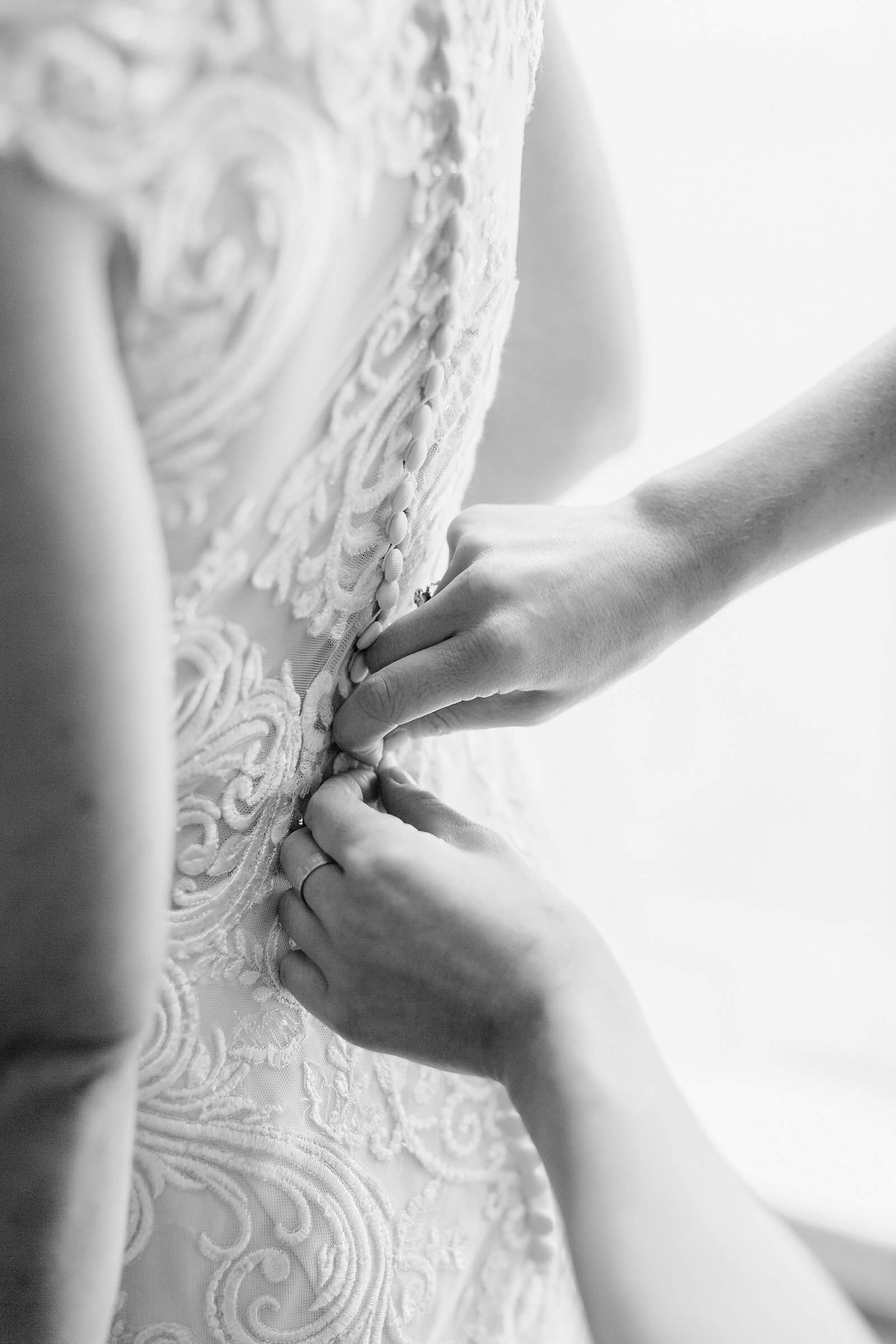 Bride getting into her dress before a wedding at The Commonwealth Club