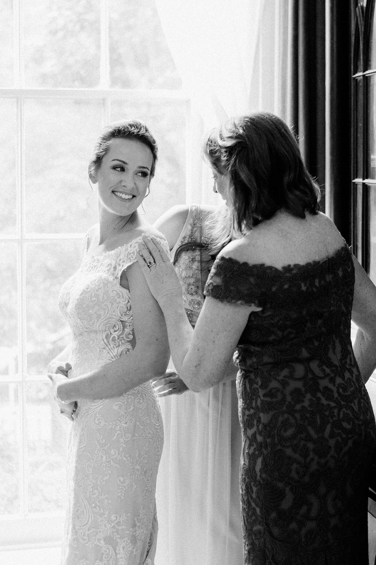 Bride getting into her dress before a wedding at The Commonwealth Club