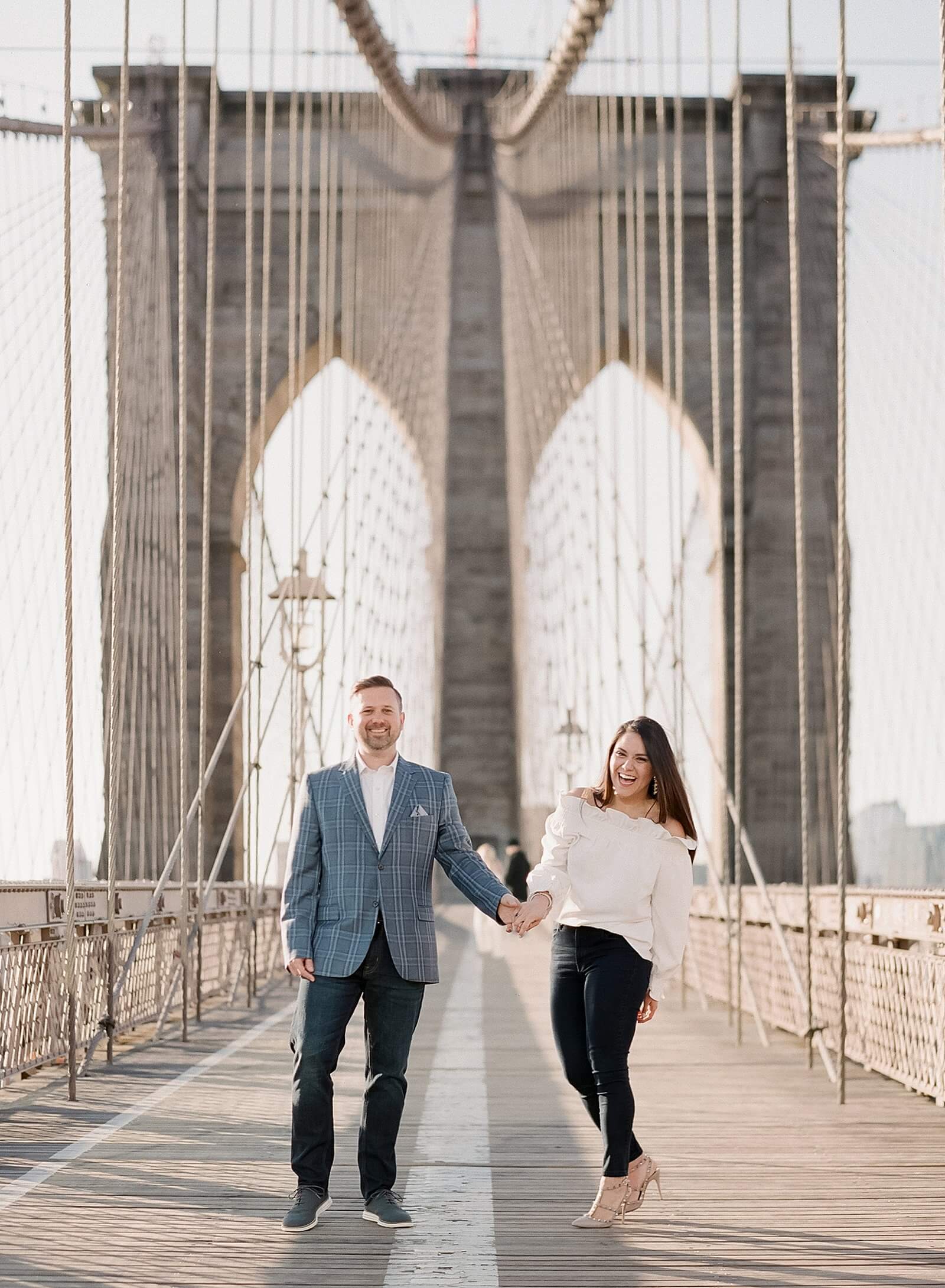 Couple during their engagement session on the Brooklyn Bridge.