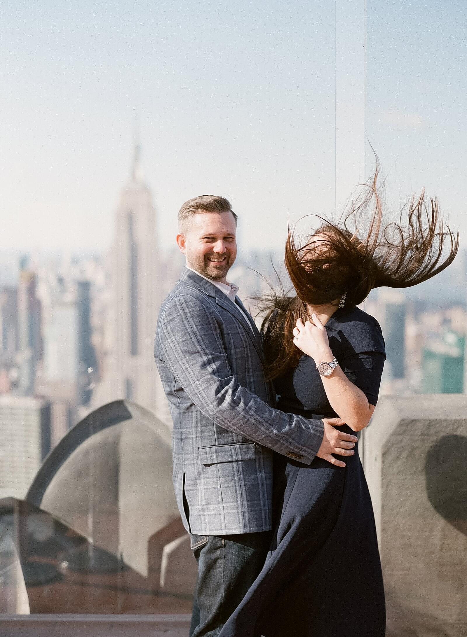 A couple during their engagement session at The Top of The Rock.