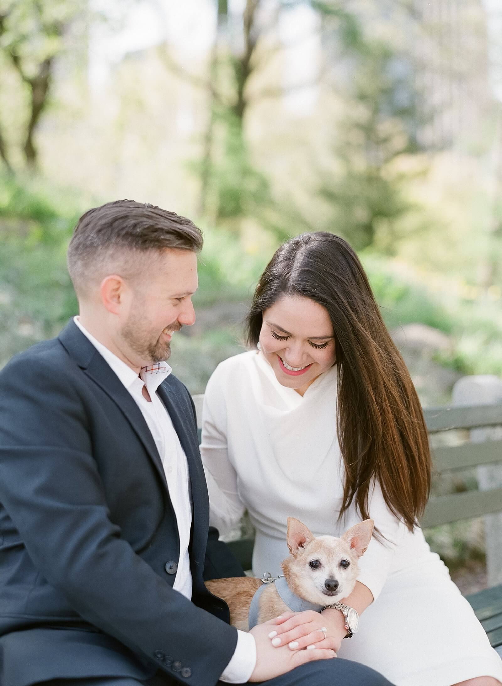A couple with their dog during their engagement session in Central Park.