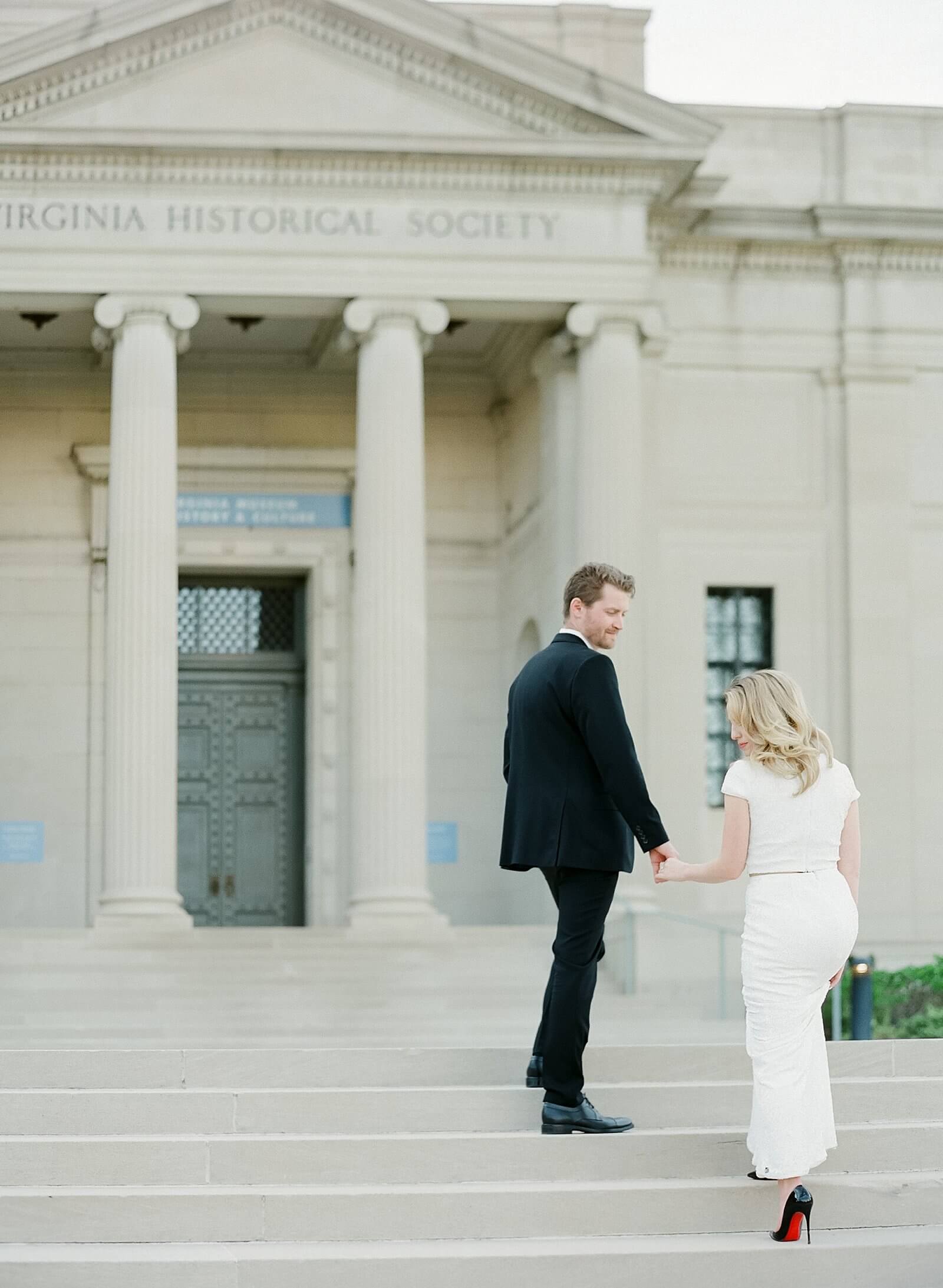 Couple amending the steps of the Virginia historical society during their engagement session
