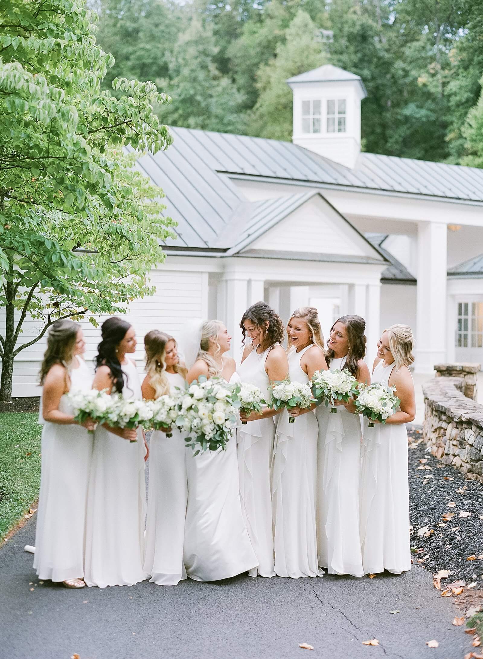 Bride with her bridesmaids in white dresses during her wedding at Trump Winery