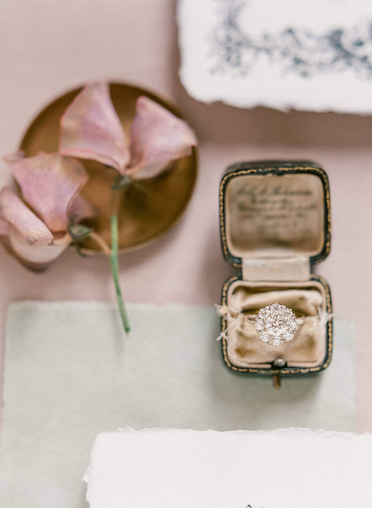 Photo of engagement ring in vintage ring box for wedding at Chateau Couffins