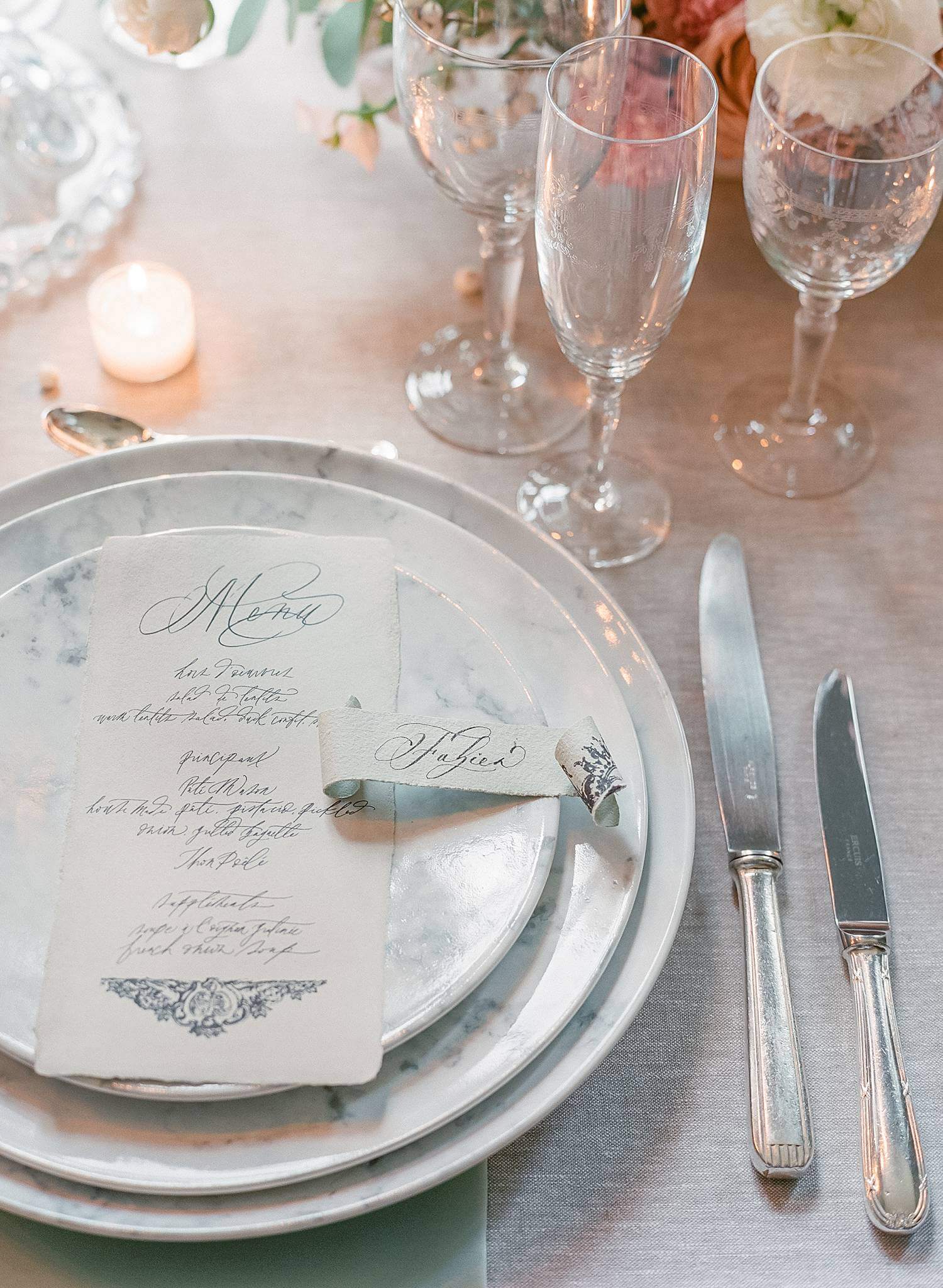 Table details of hand written menus and place cards at reception for an elopement at Chateau Couffins in Bordeaux France