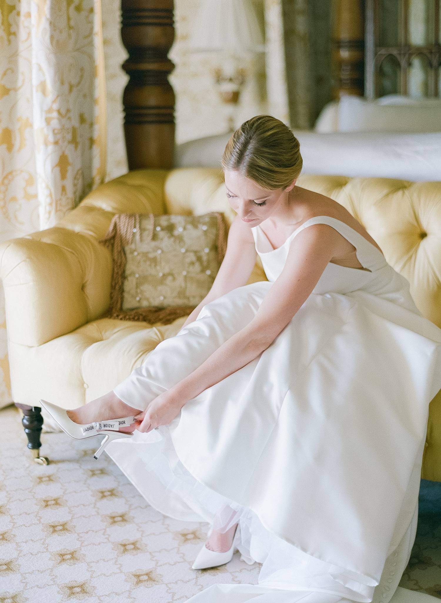 Bride slipping her Dior heels on for her wedding.