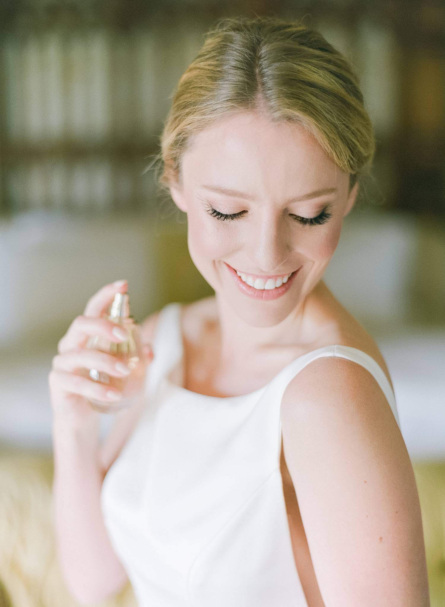 Bride putting on her Dior Perfume.