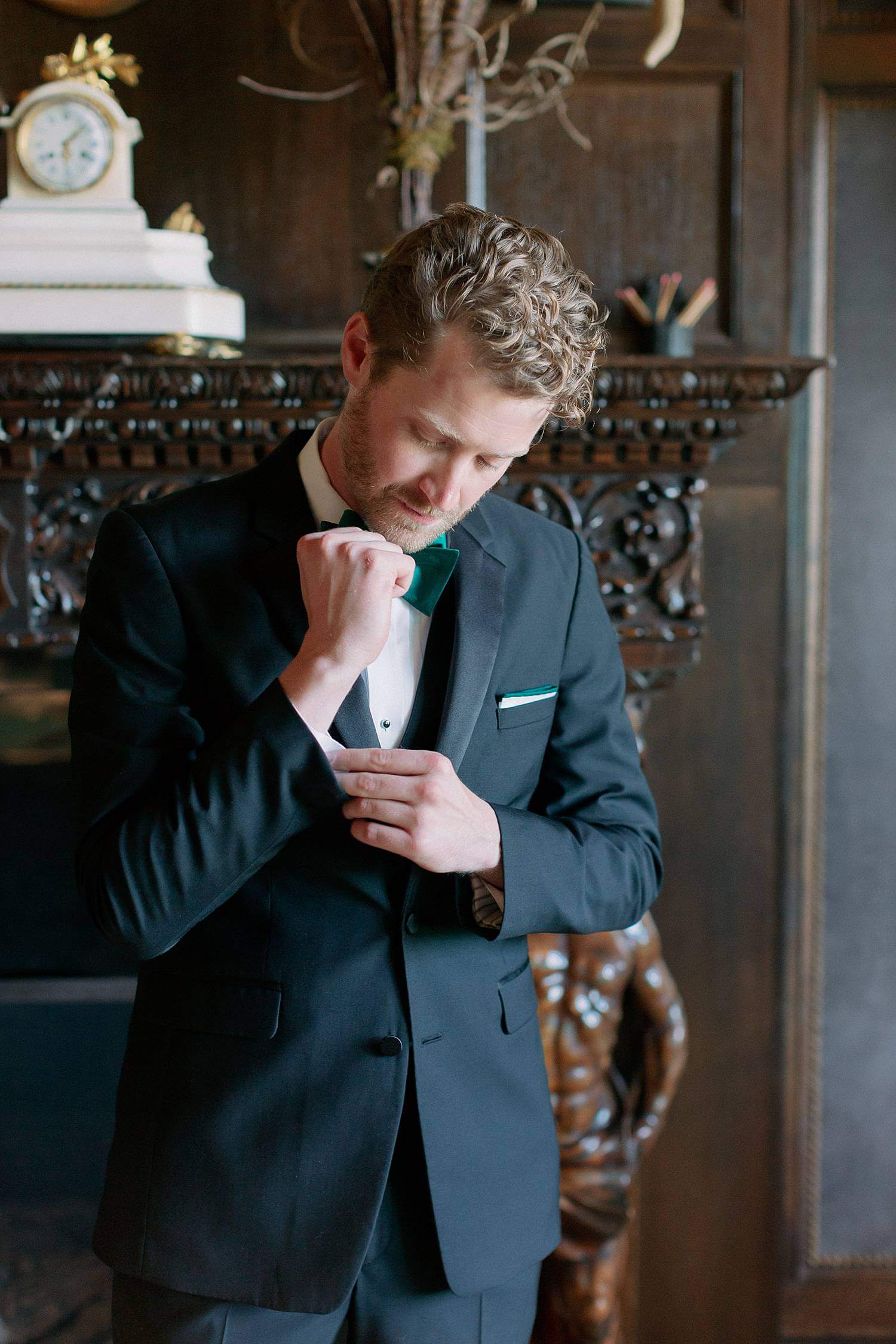 Groom adjusting his cufflinks before his wedding.
