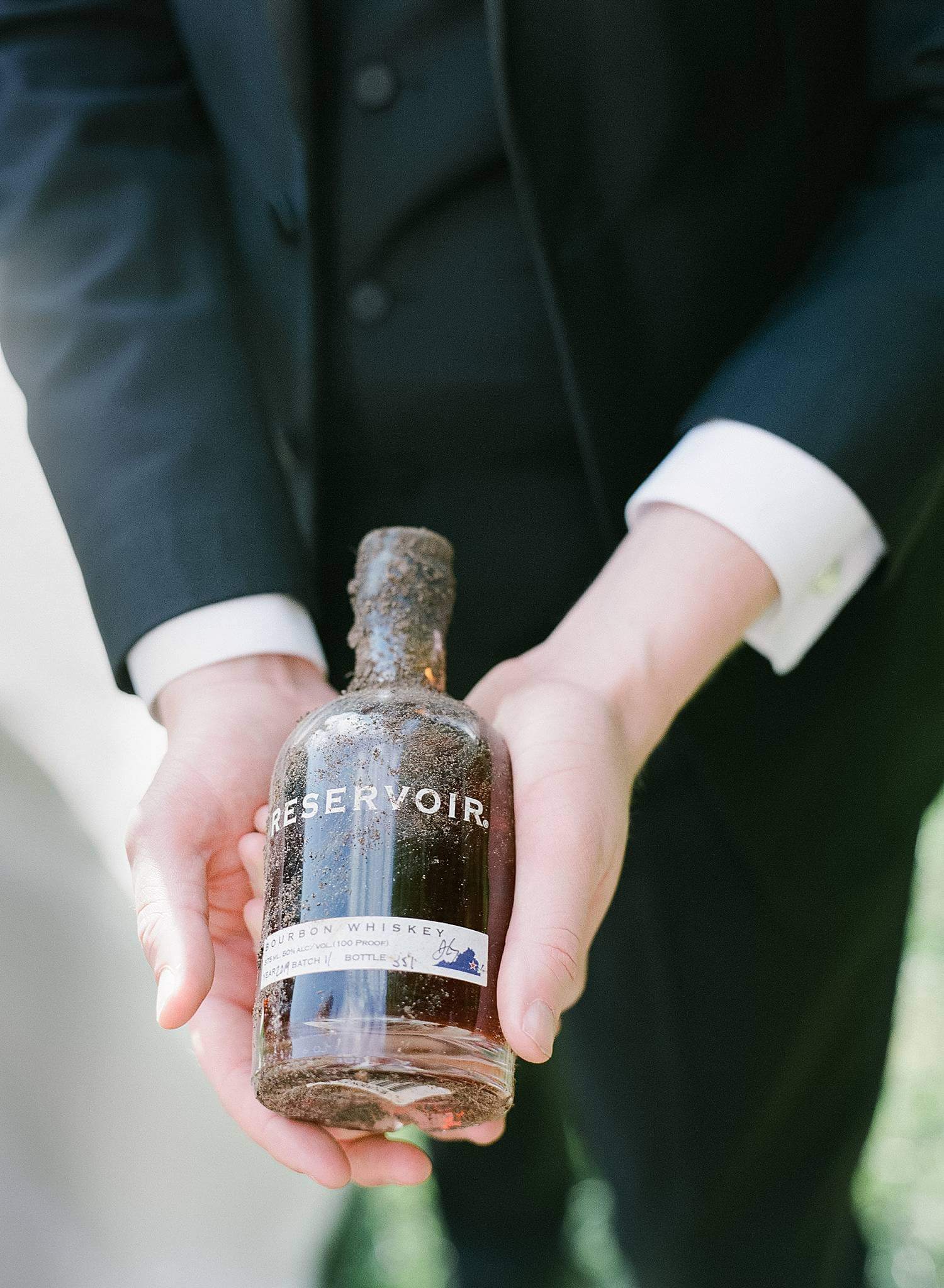 Bride and groom digging up the bourbon during their wedding at Dover Hall Estate.