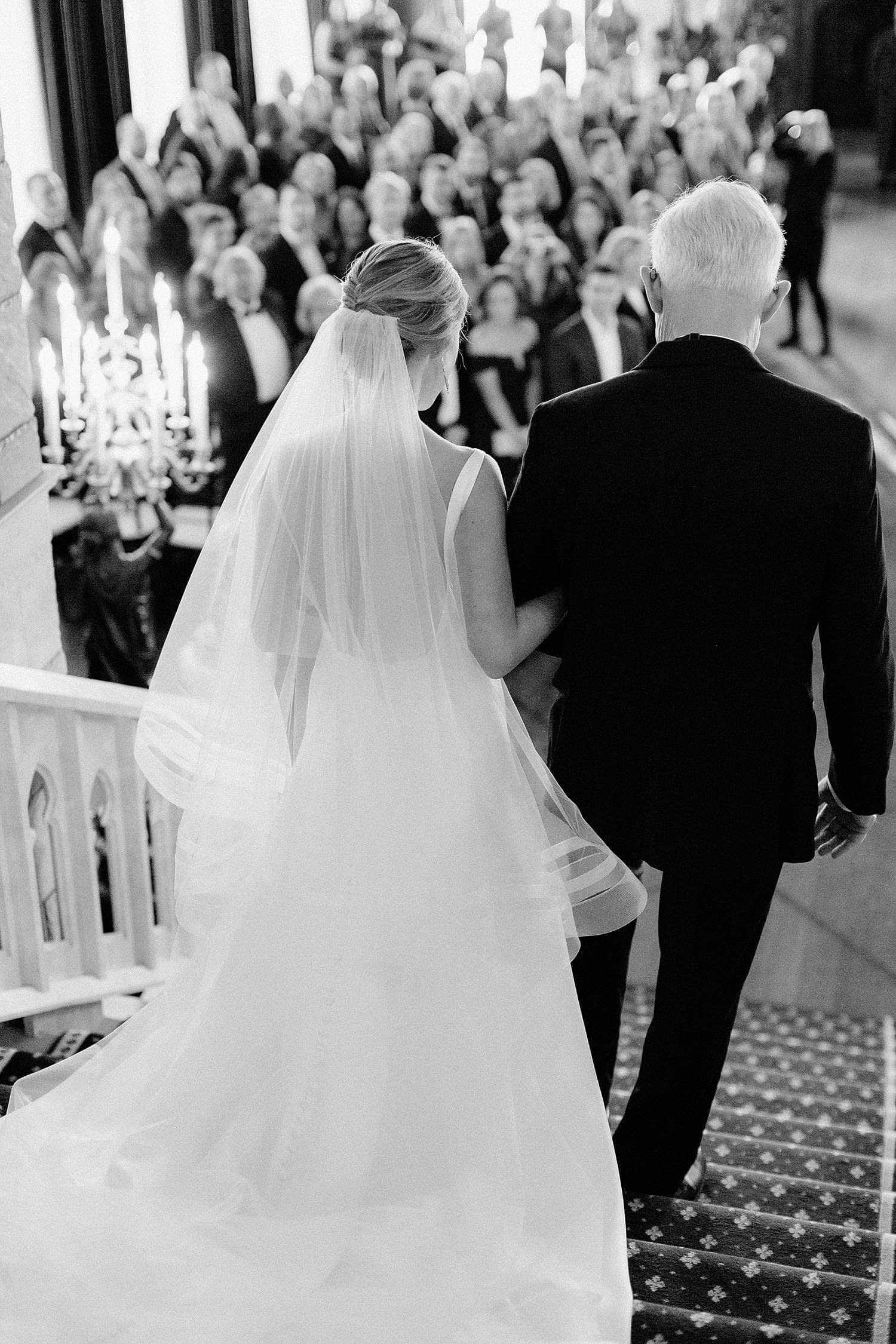 Bride and father depending main staircase during ceremony at Dover Hall Estate
