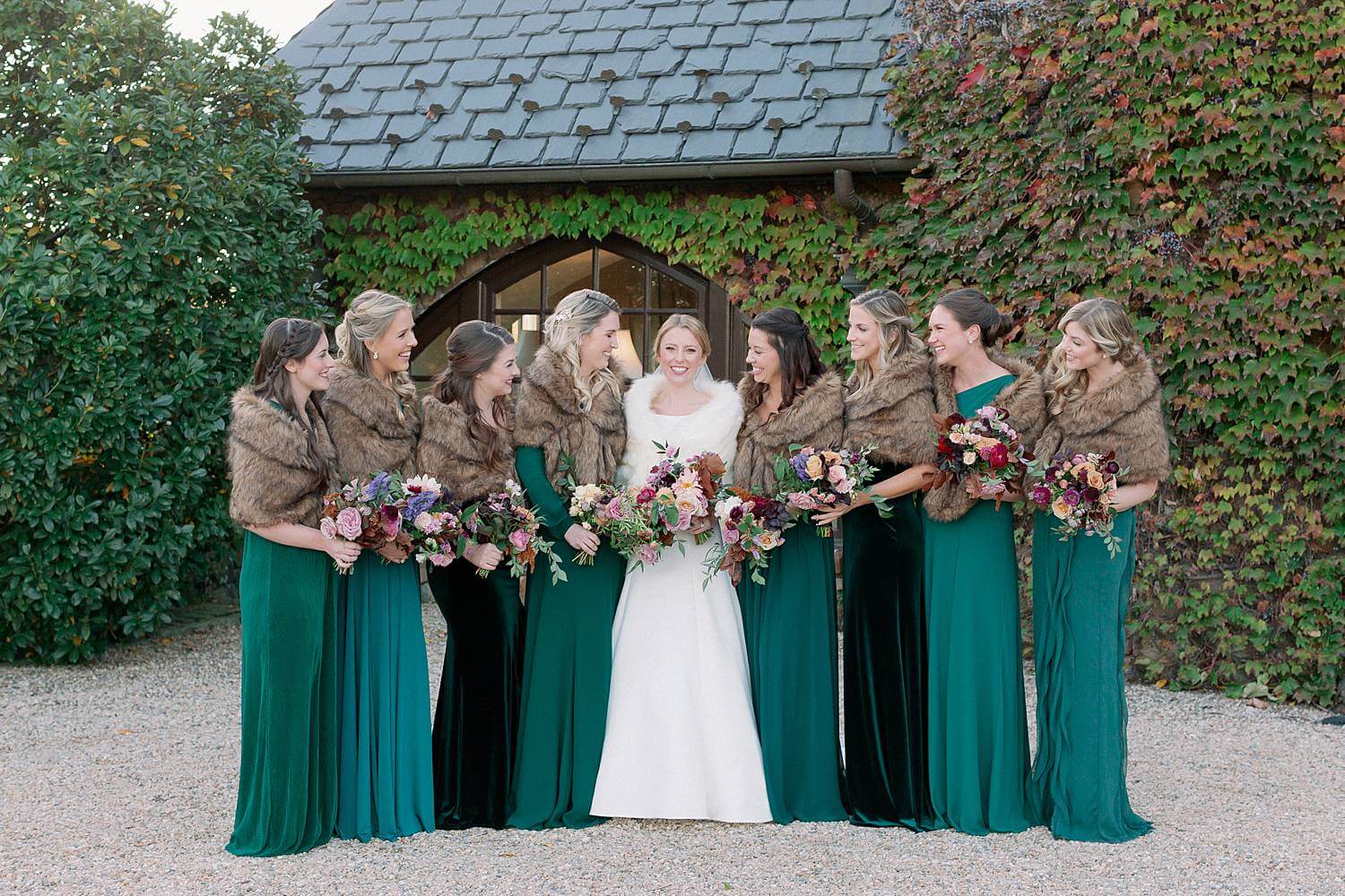 Bride and bridesmaids laughing together during portraits at Dover Hall Estate
