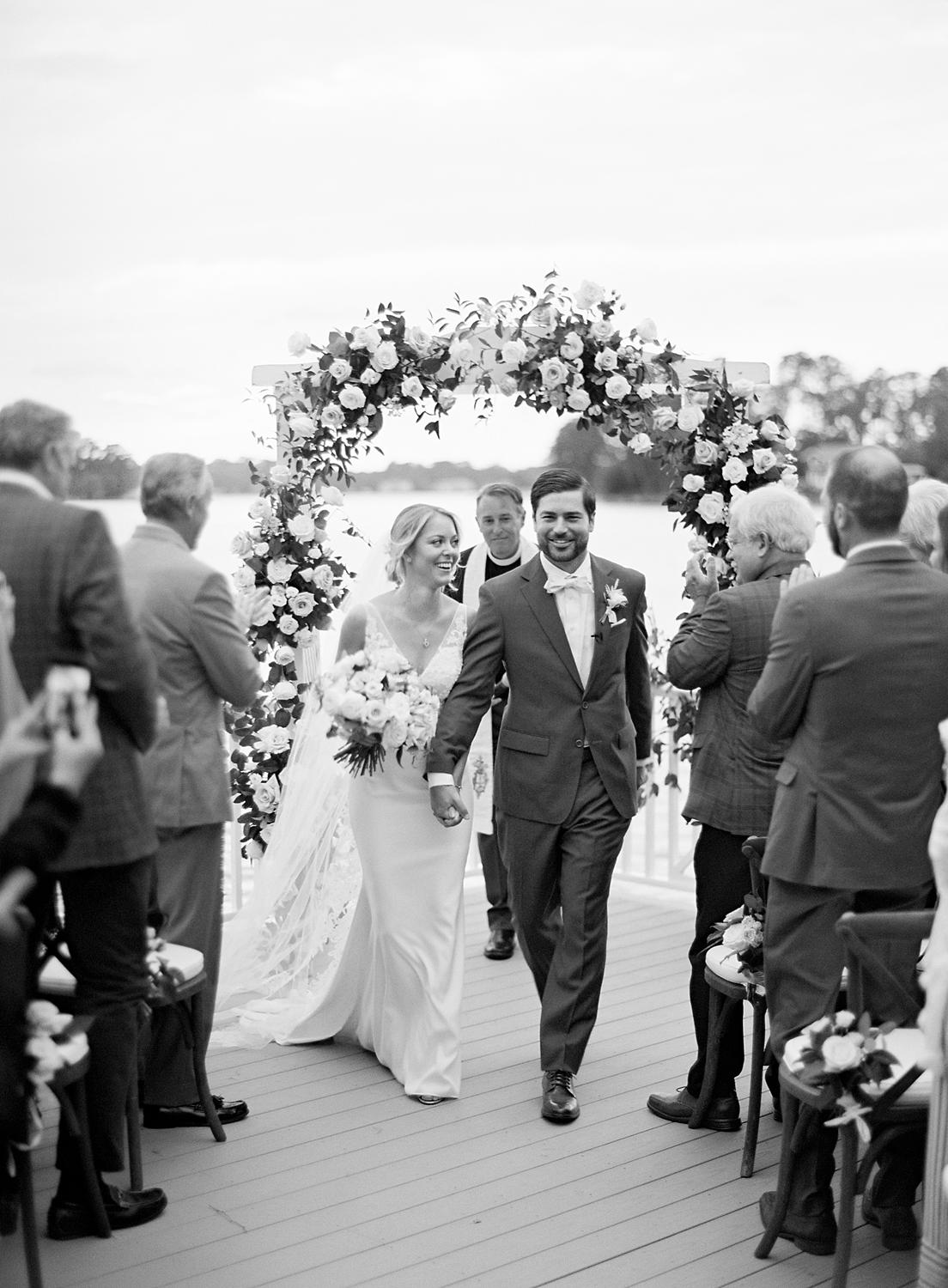 Bride and groom announced as husband and wife exiting their intimate home wedding