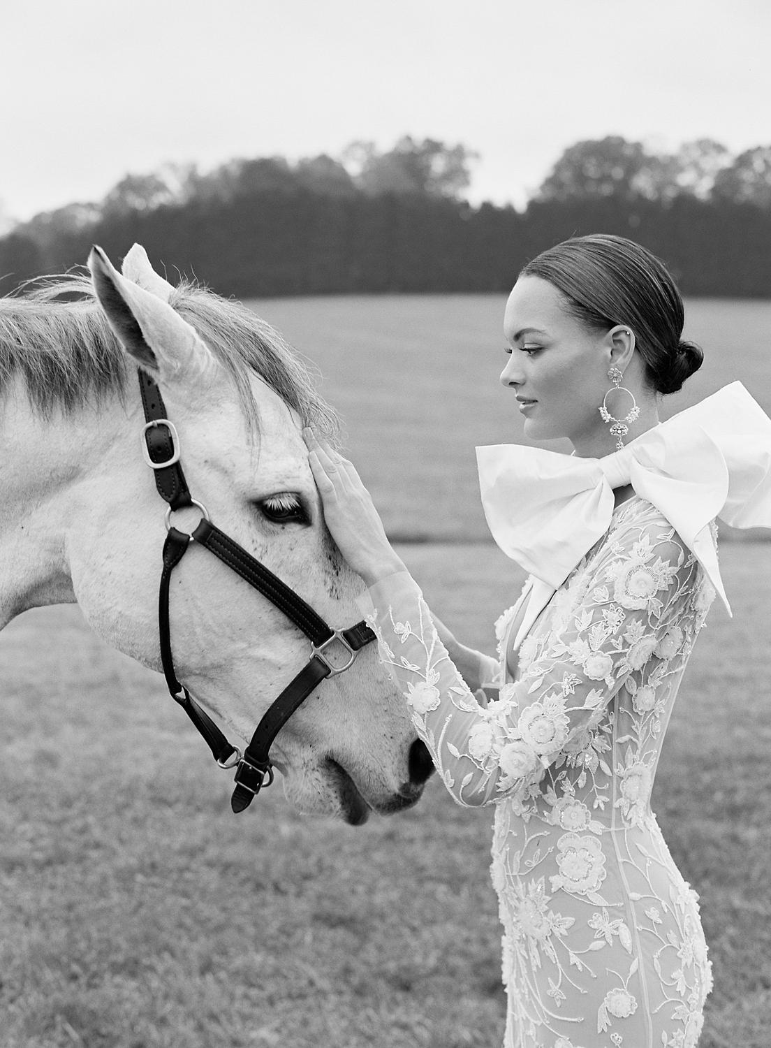 Bride greeting horse during her wedding at Dover Hall