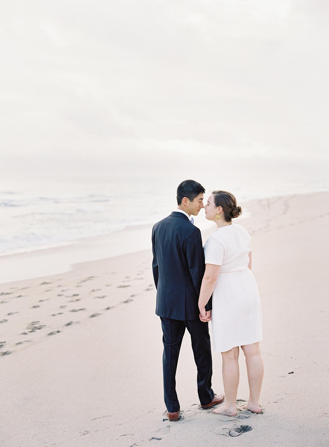 Bride and groom walking in the sand during their Palm Beach Elopment