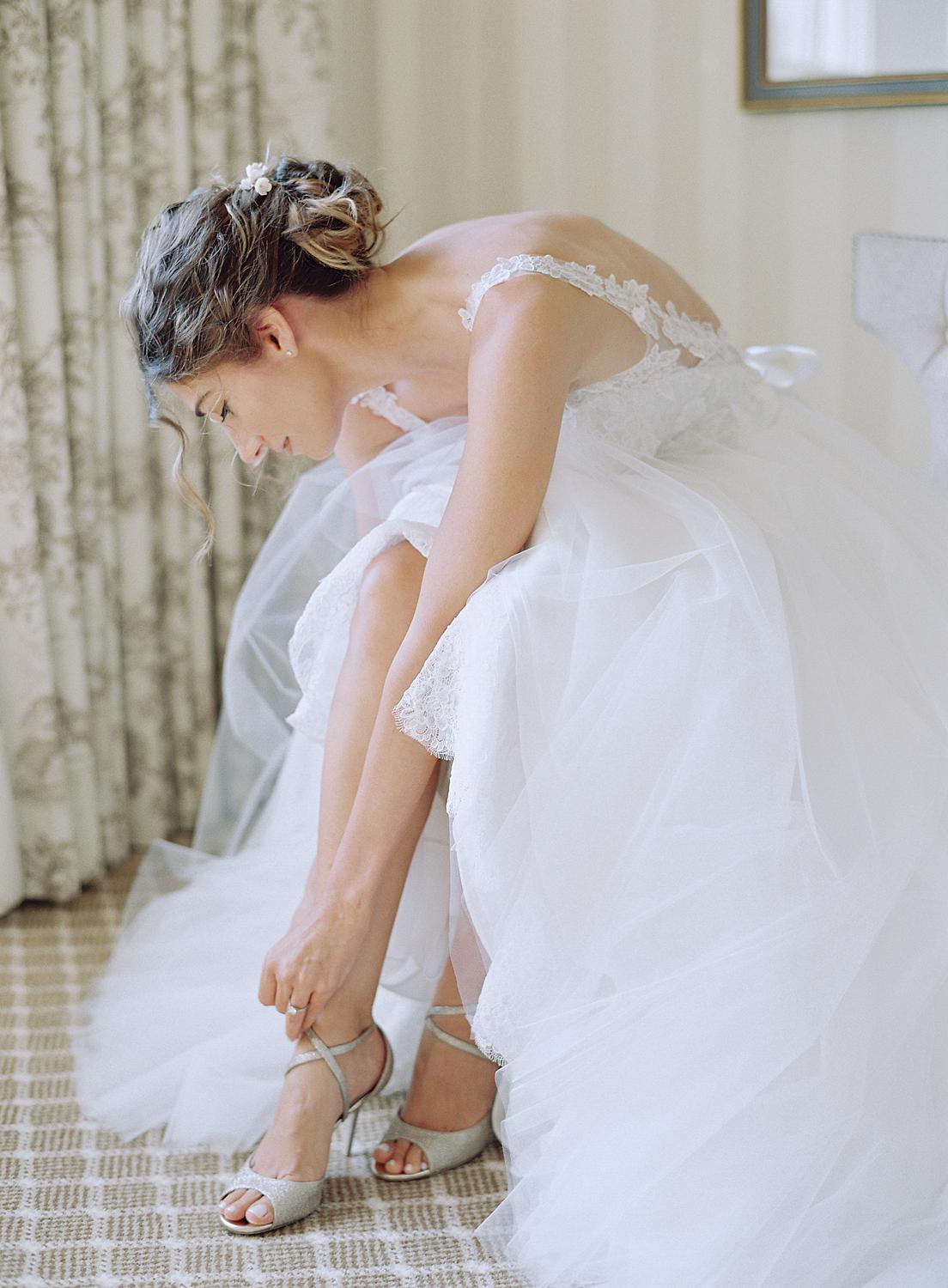 Bride putting on her shoes for her wedding at DAR Constitution Hall