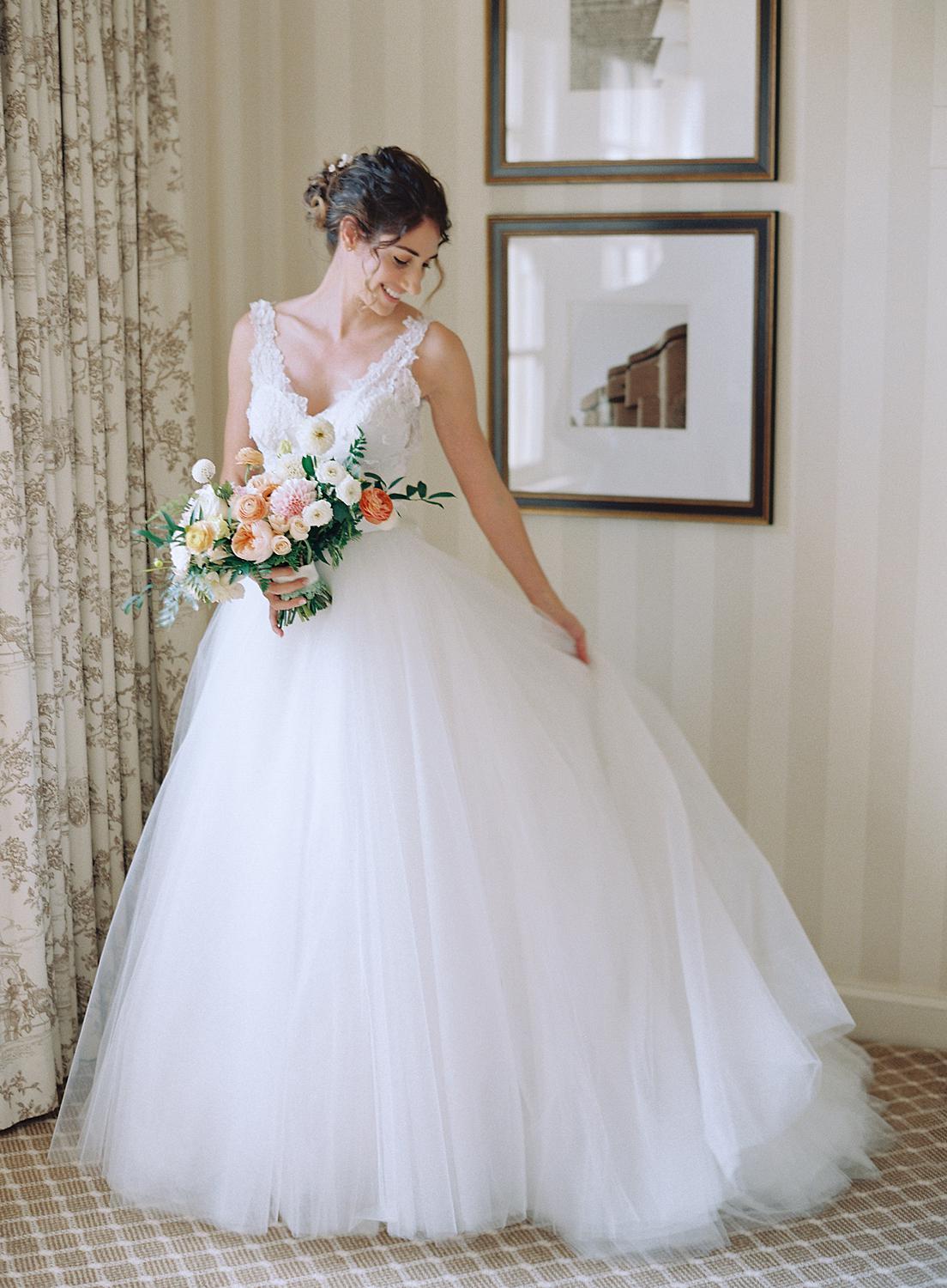 Bride adjusting her dress before her wedding at DAR Constitution Hall