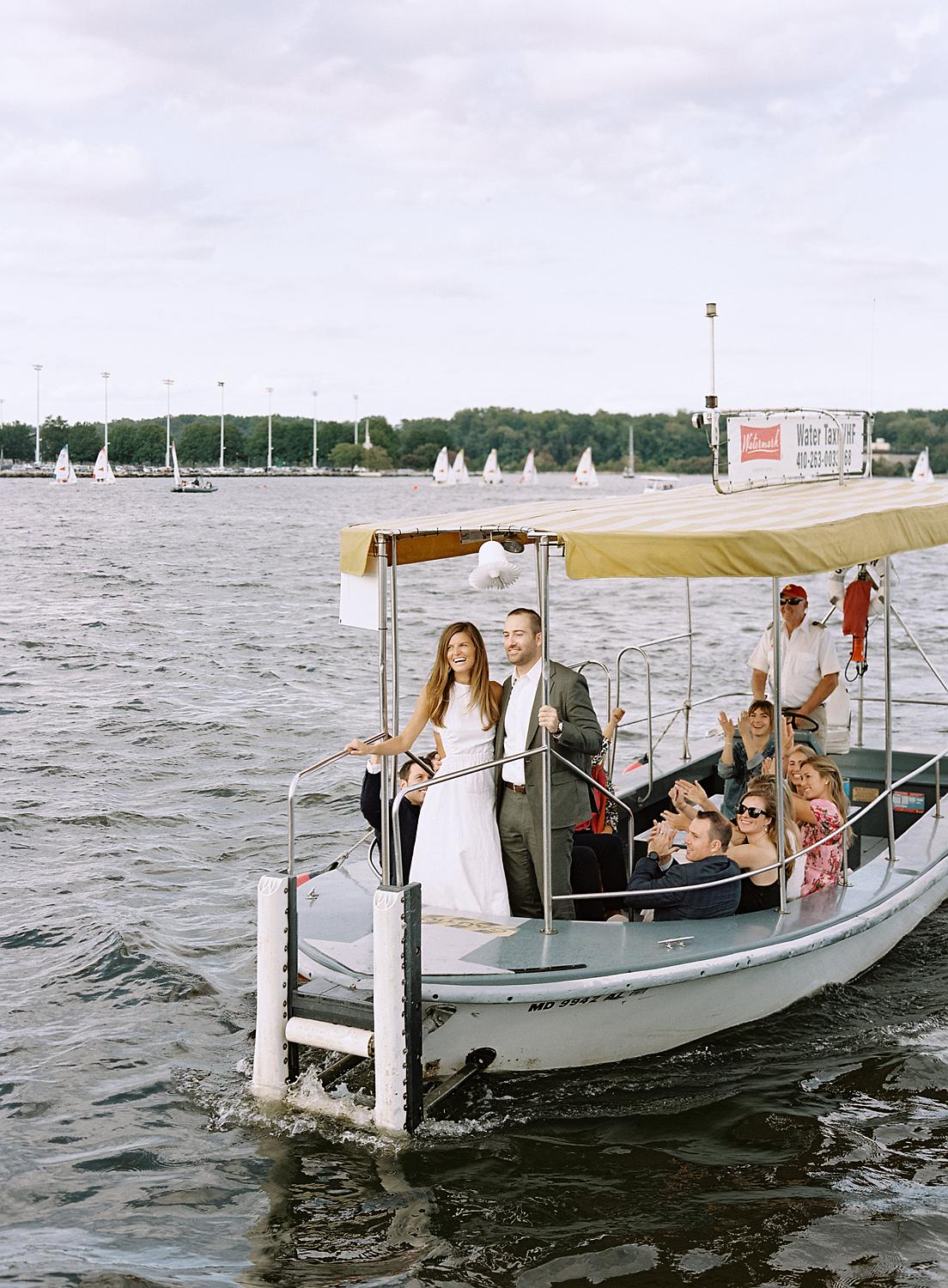 Bride and groom pulling in to the Annapolis harbor in a water taxi.