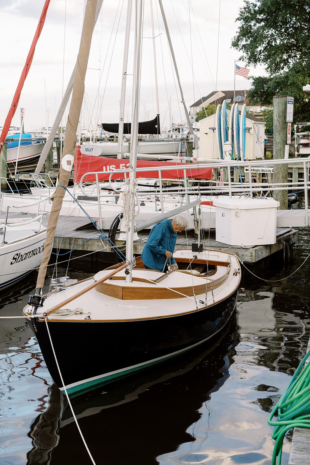 Sailor cleaning his boat in Annapolis Harbor.