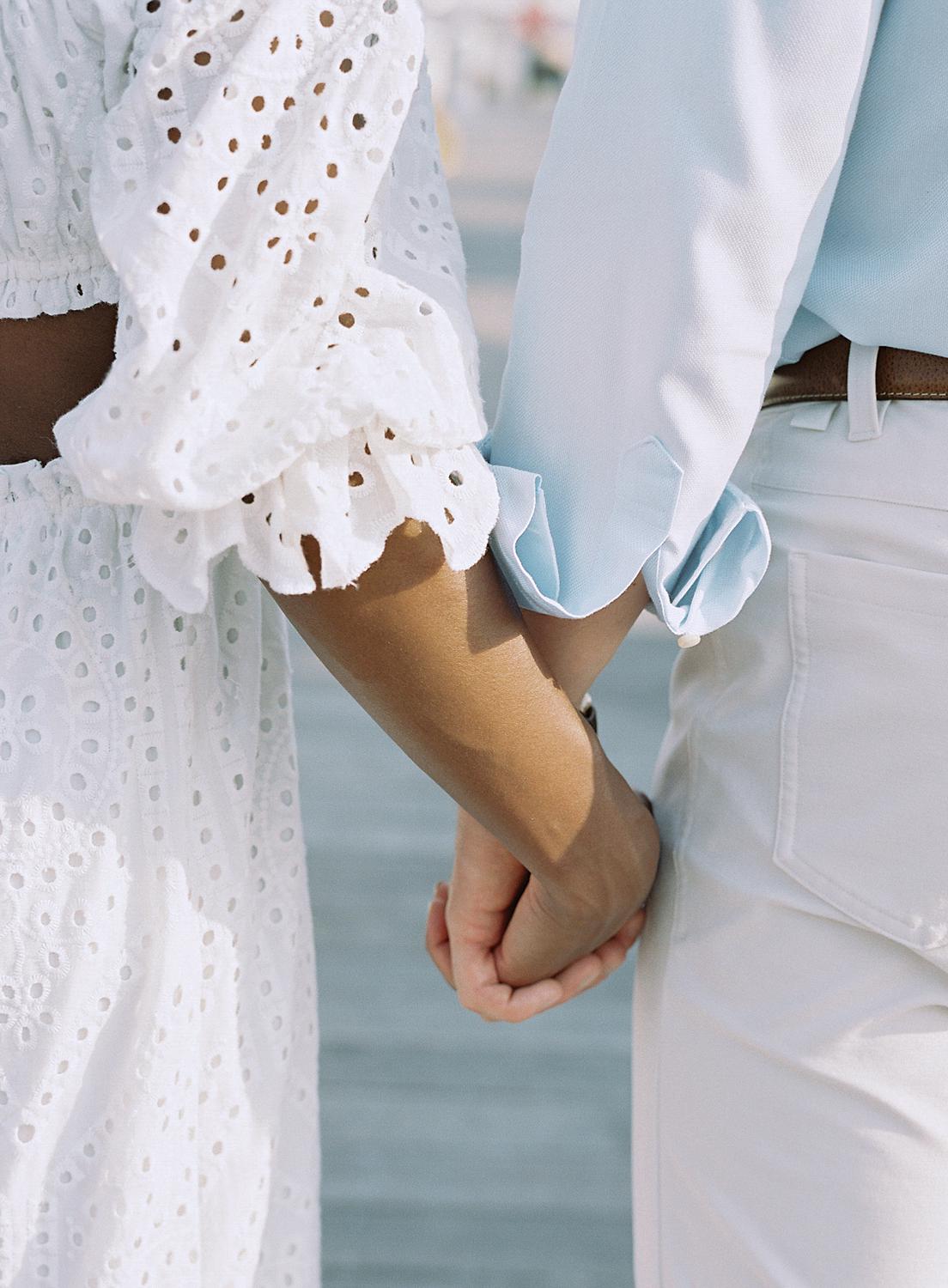 Bride and groom holding hands during Annapolis engagement session.
