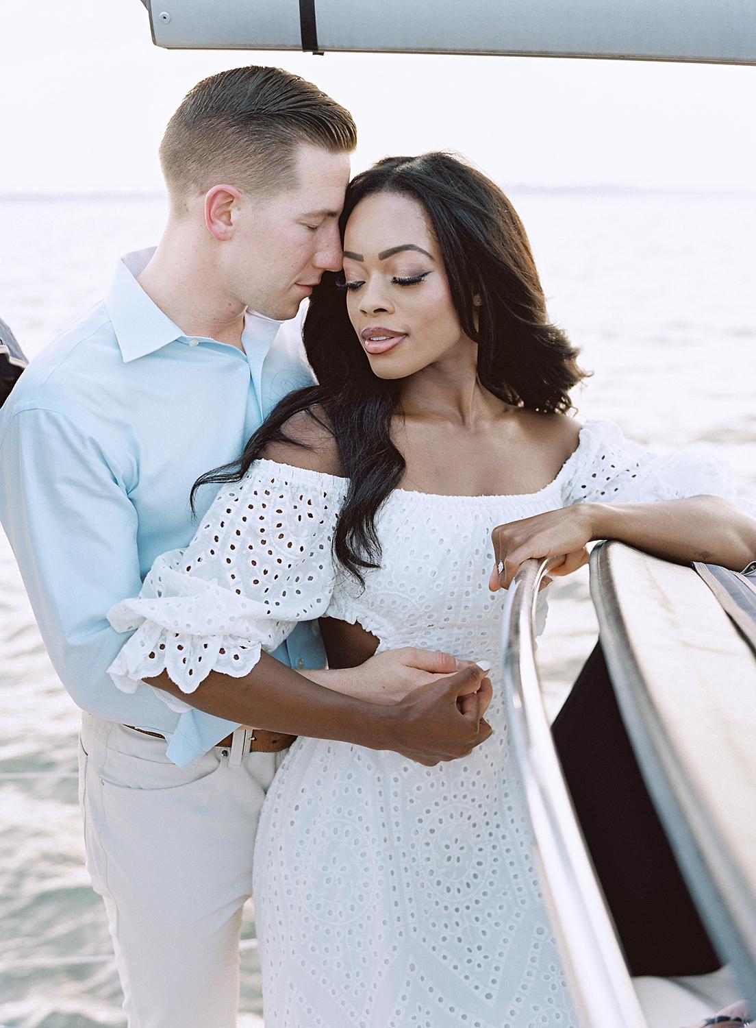 Groom holding bride during their Annapolis engagement session.