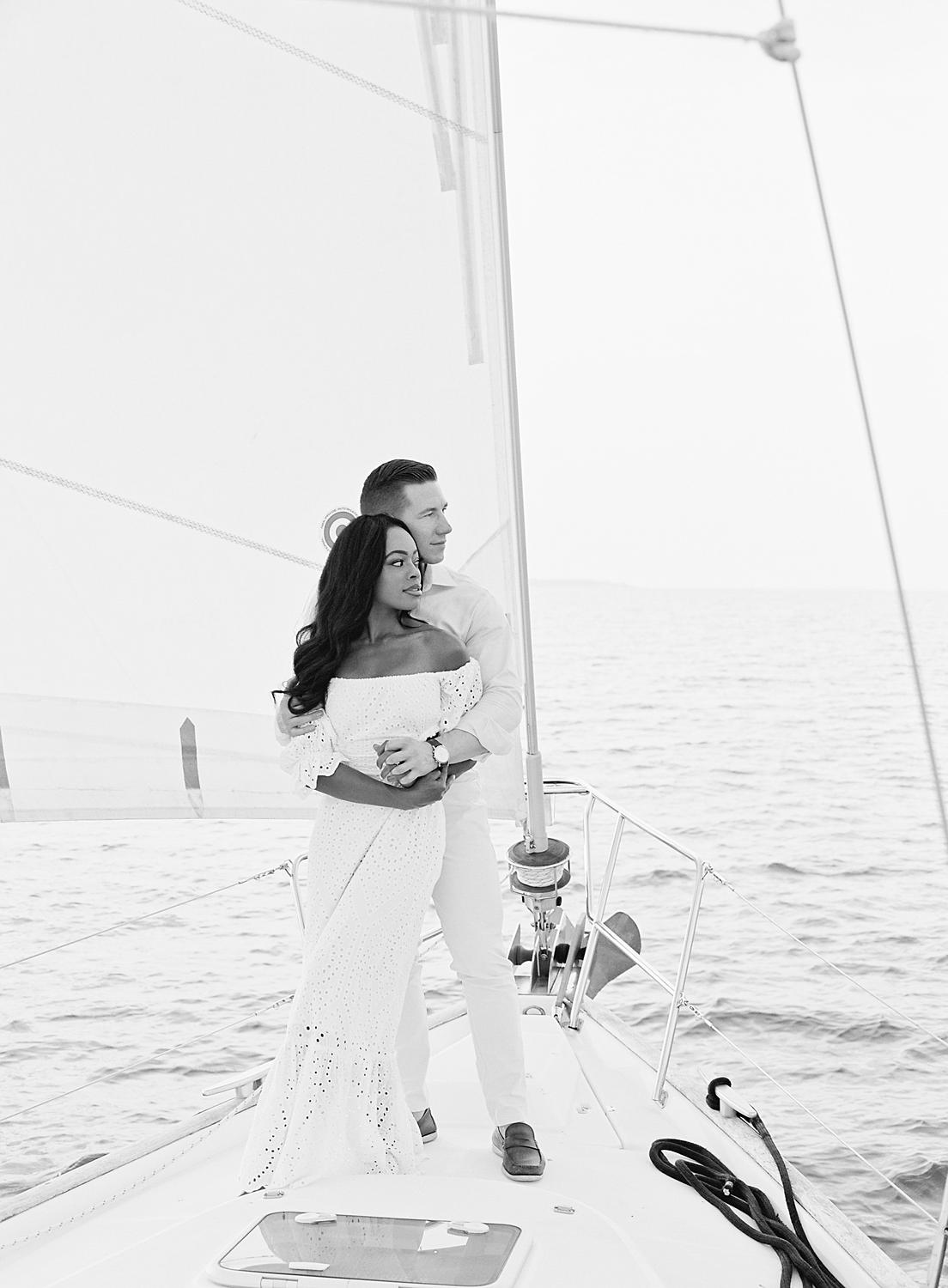 Couple holding each other on the boat over the Chesapeake Bay.