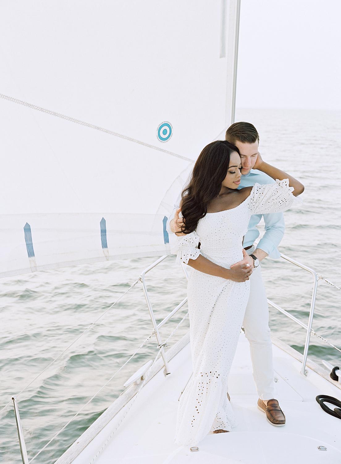 Bride pulling in groom during their Annapolis Harbor engagement session.