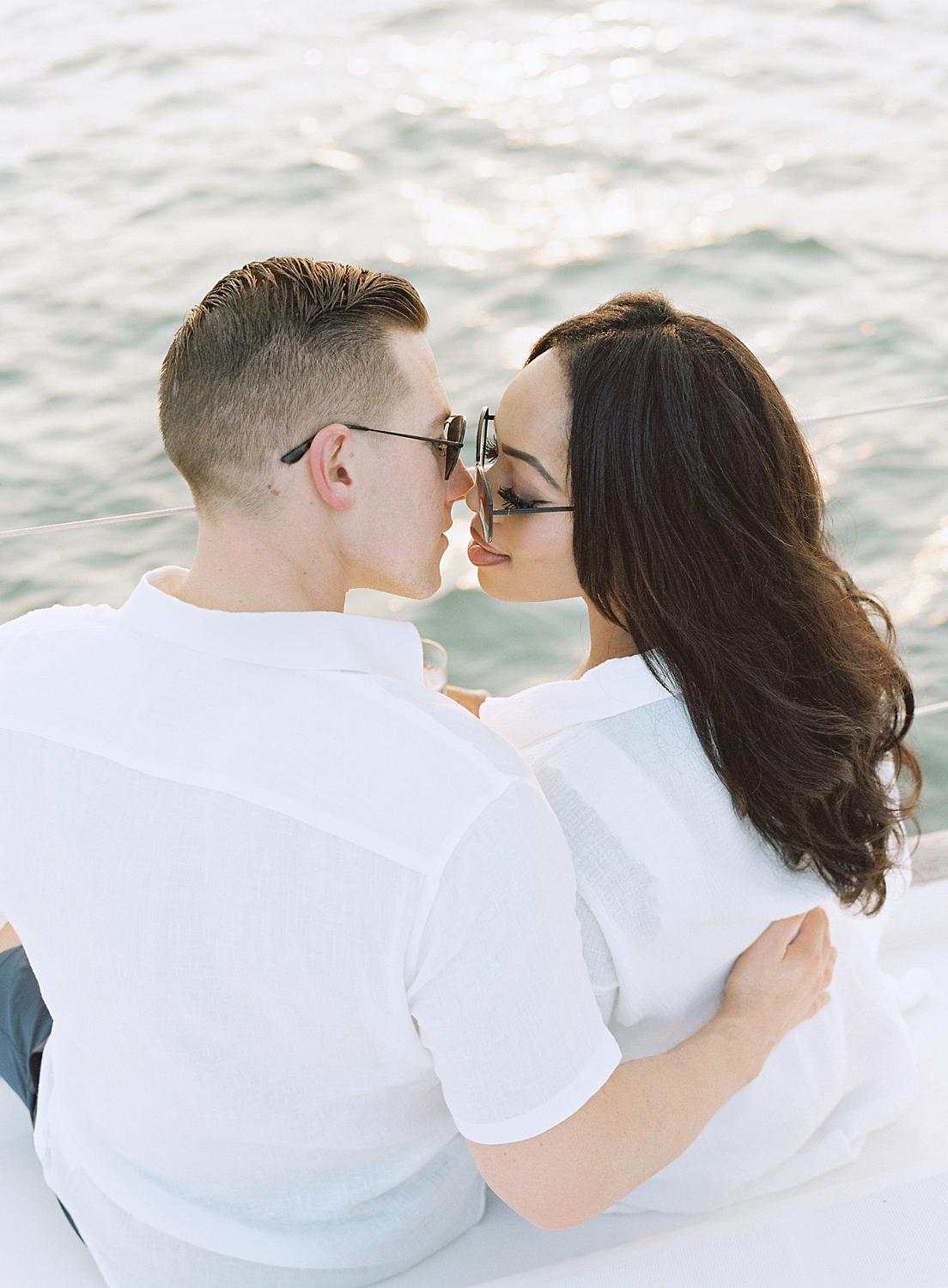 Bride and groom kissing during an engagement session in The Annapolis Harbor.