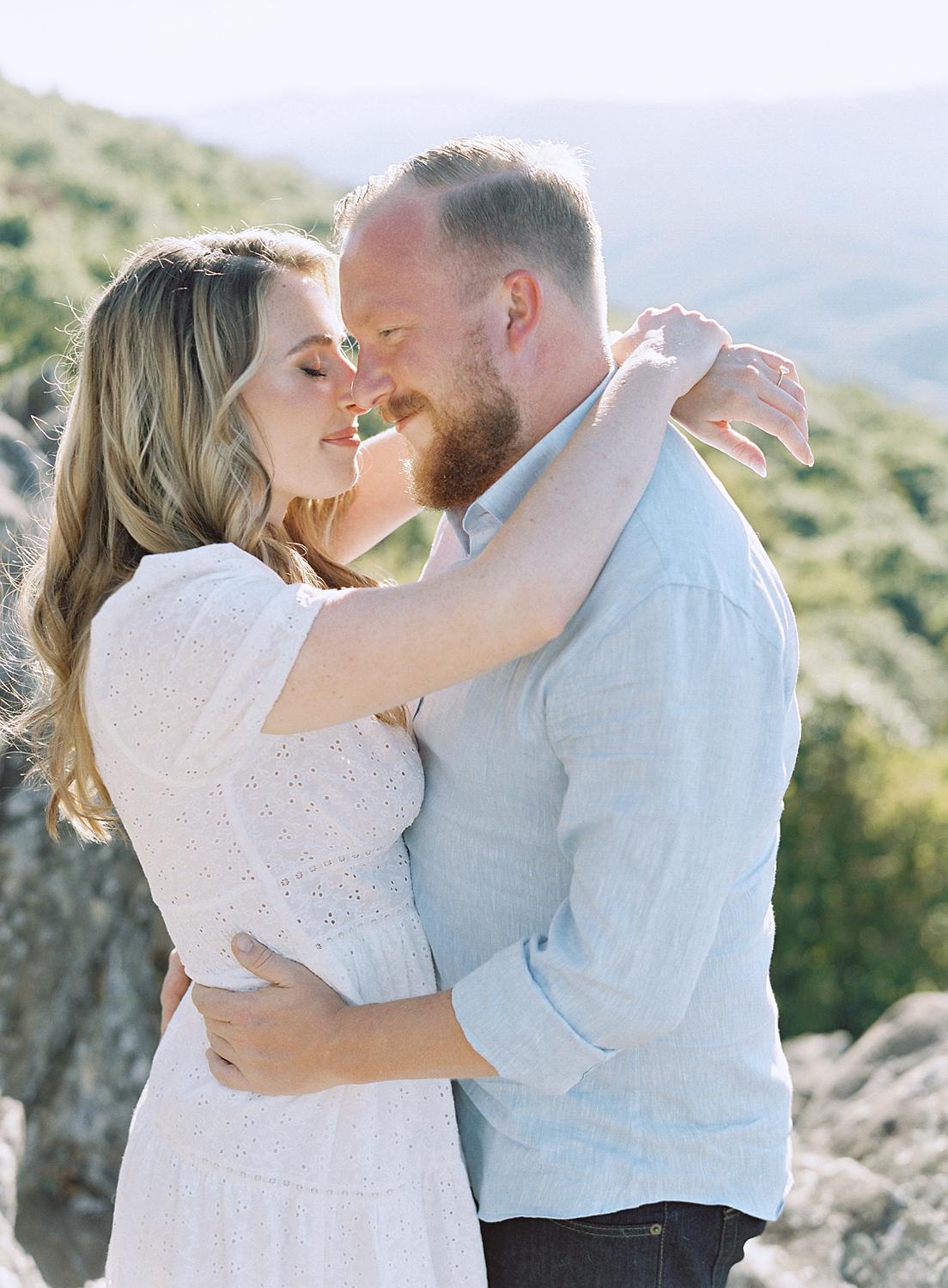 Bride and groom embracing during their Blue Ridge Mountains engagement session at Ravens Roost.