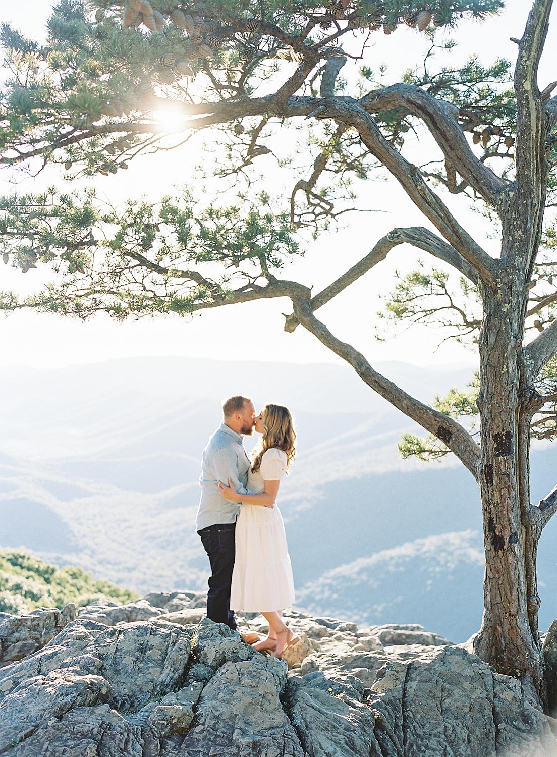 Bride and groom kissing atop Ravens Roost at their Blue Ridge Mountains engagement session.