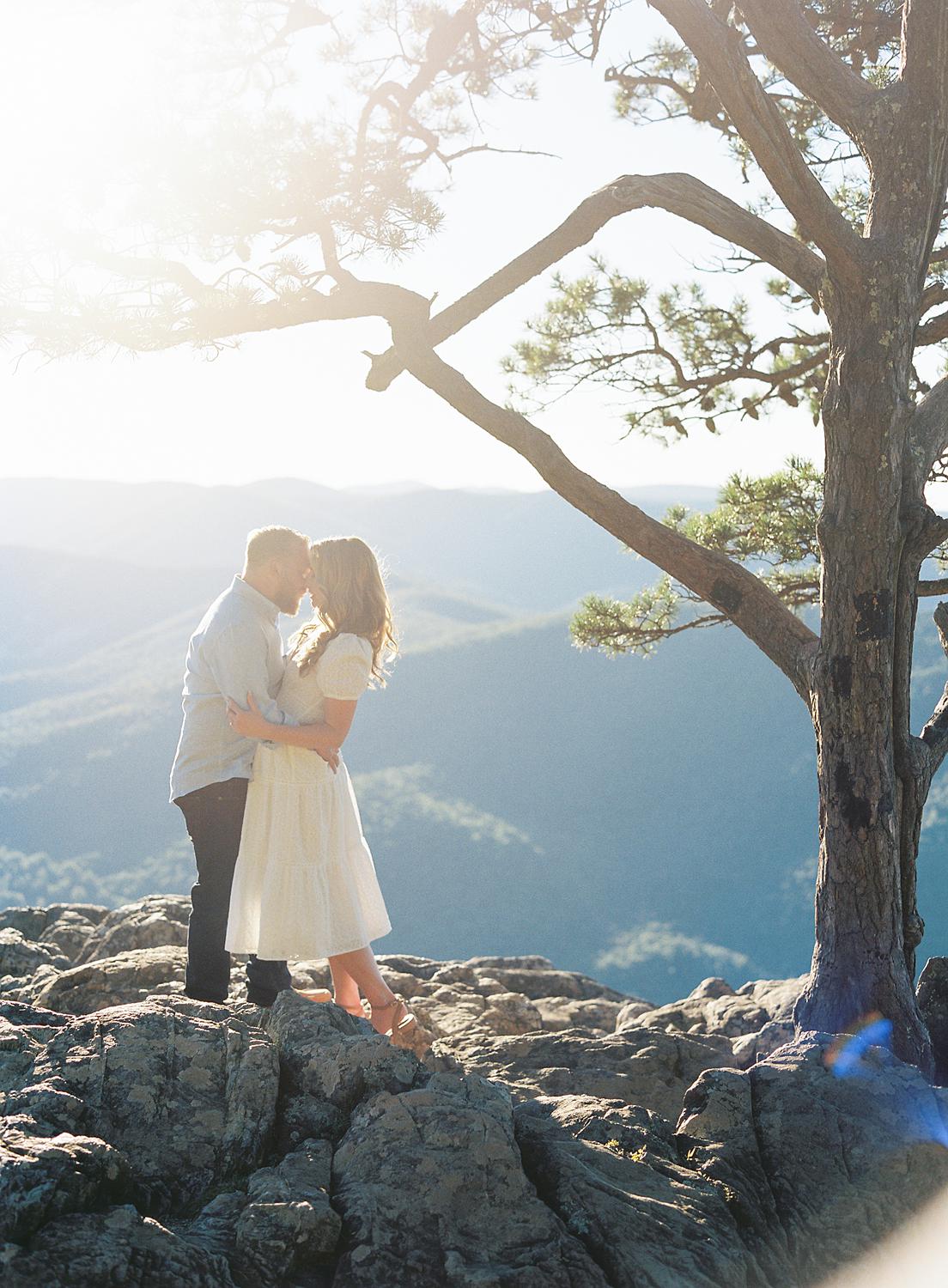 Bride and groom embracing atop Ravens Roost at their Blue Ridge Mountains engagement session.