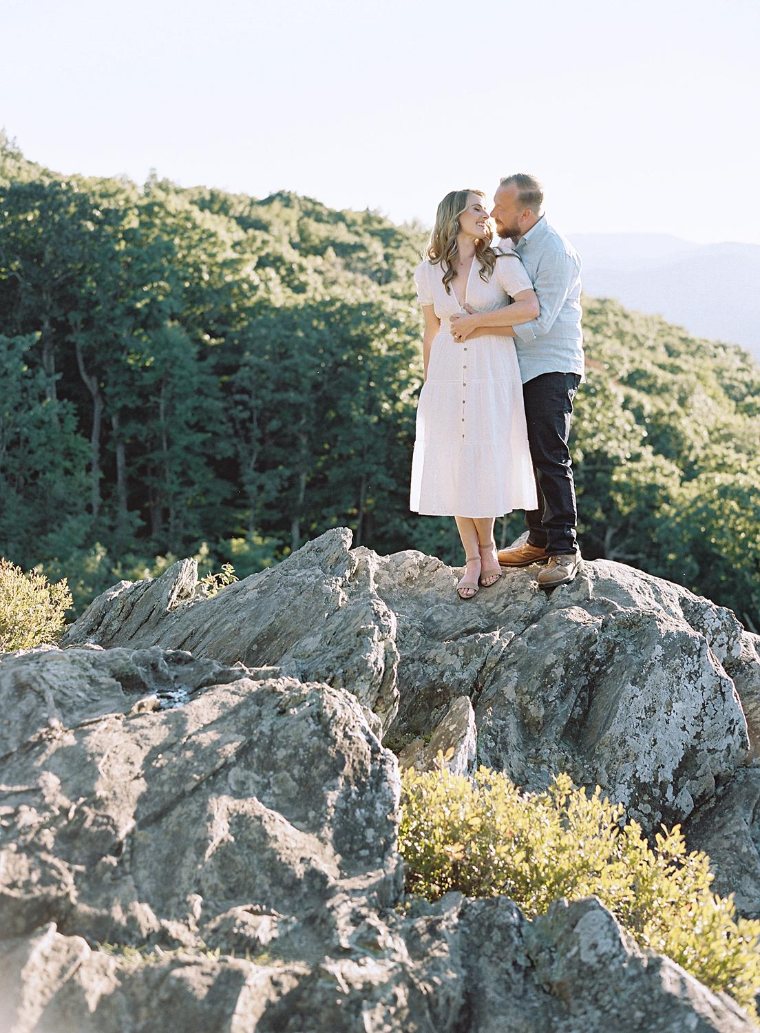 Bride and groom embracing at their Blue Ridge Mountains engagement session atop Ravens Roost.