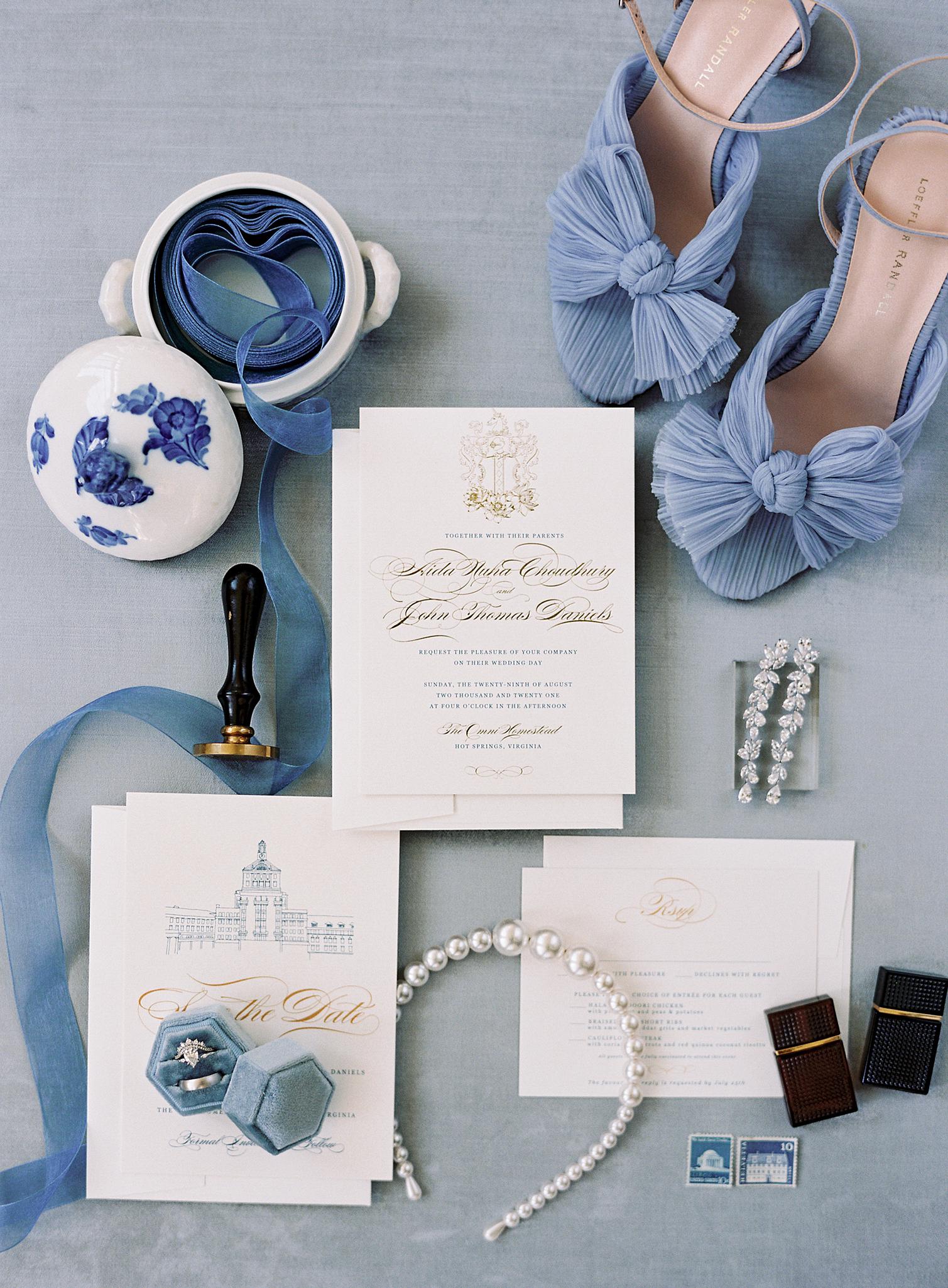 Invitation suite details with wedding bands and shoes.