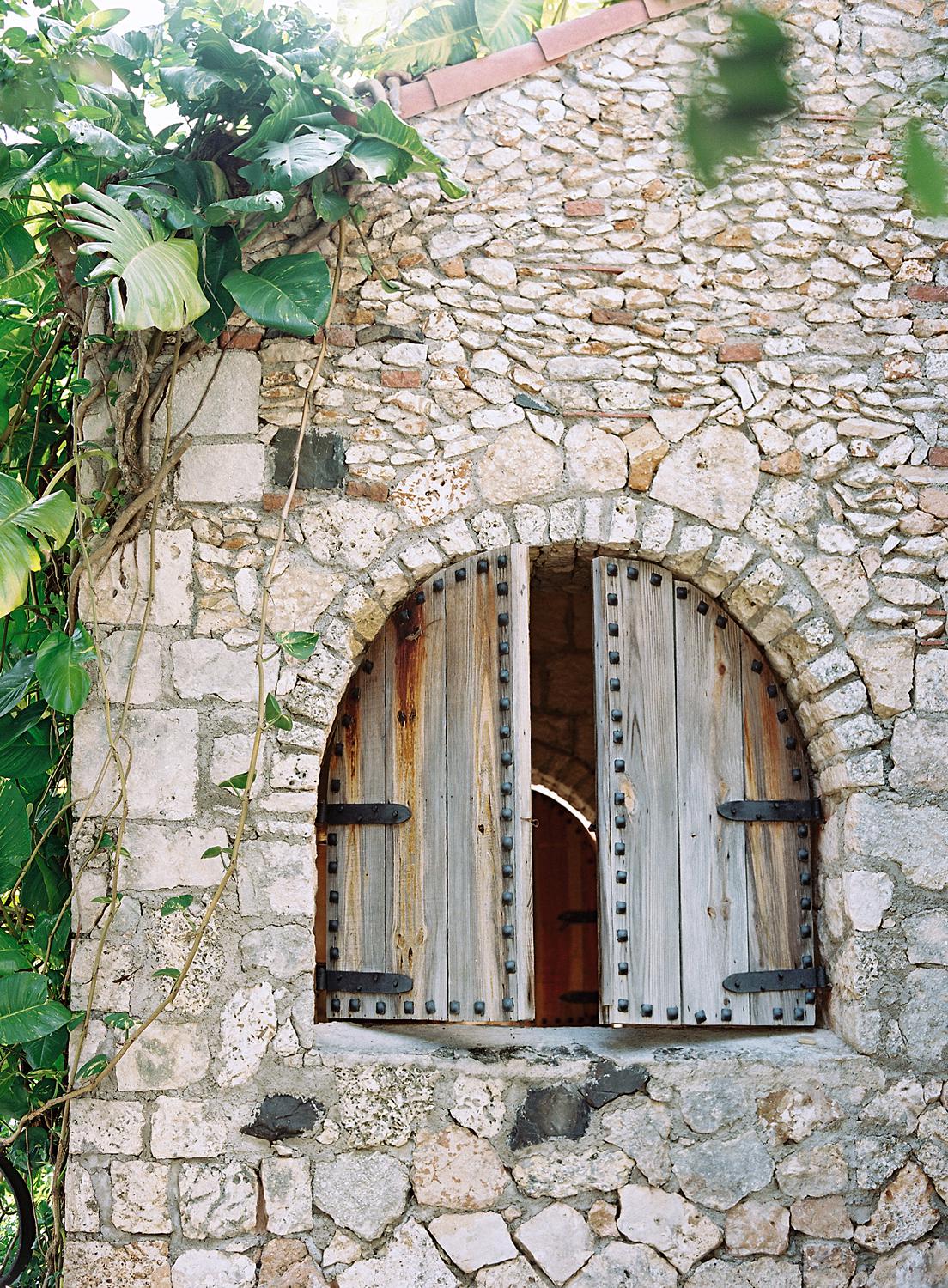 Wooden window doors in rock wall
