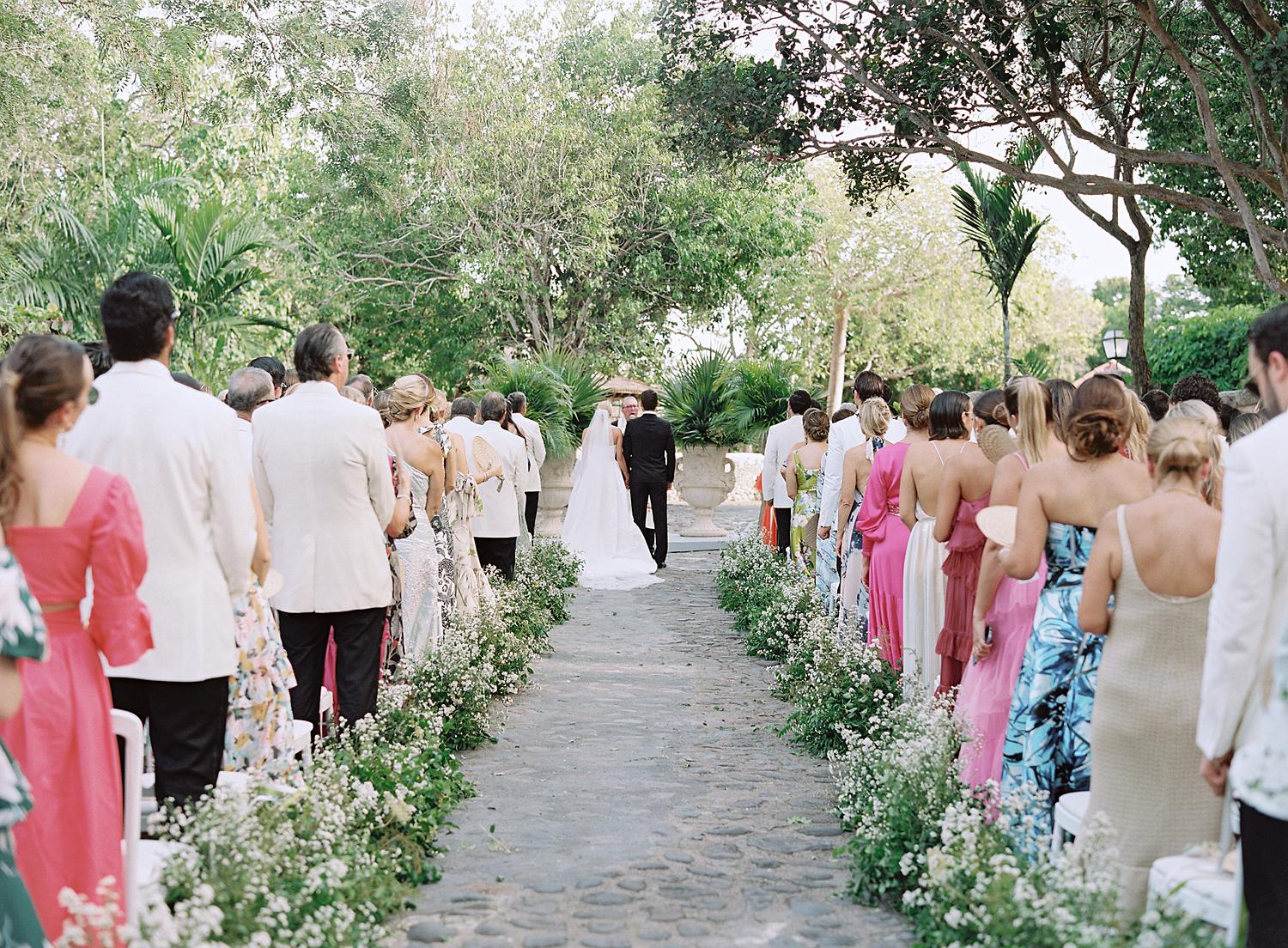 Wide shot of ceremony as the bride and groom get married at Altos de Chavón.