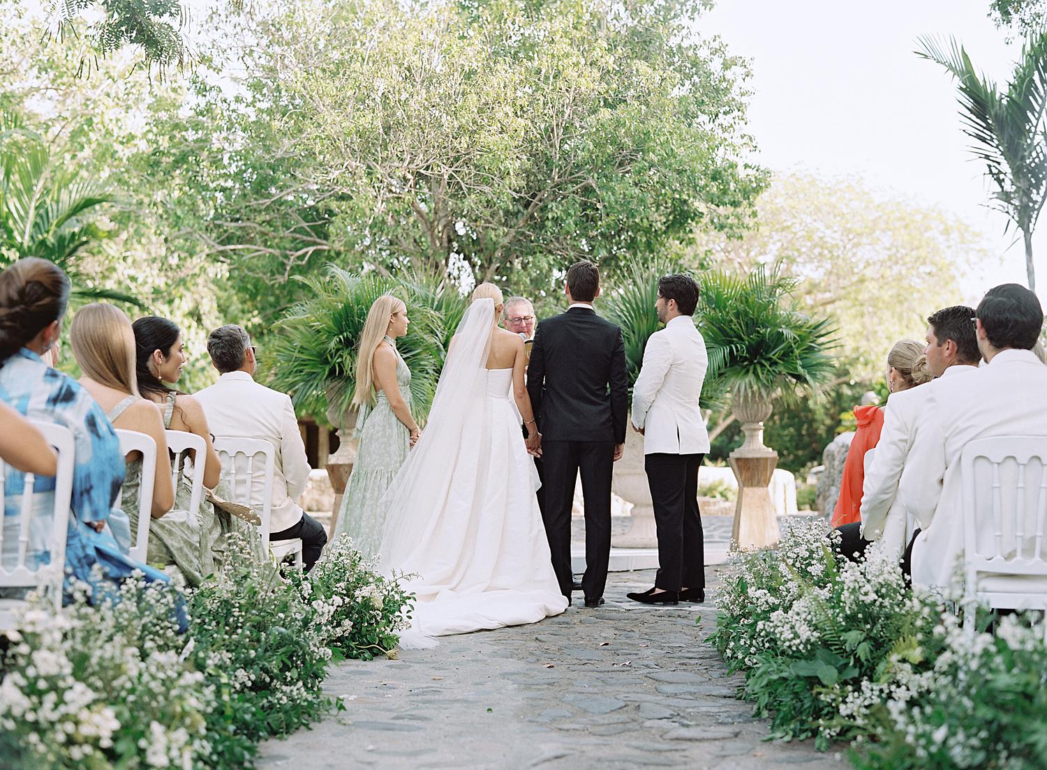 Bride and groom listing to officiant during their Altos de Chavón wedding.