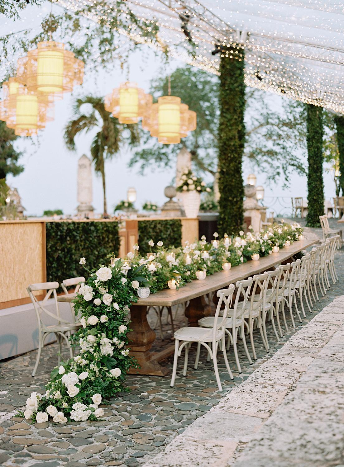 Long table with cascading florals at reception during an Altos de Chavon wedding.