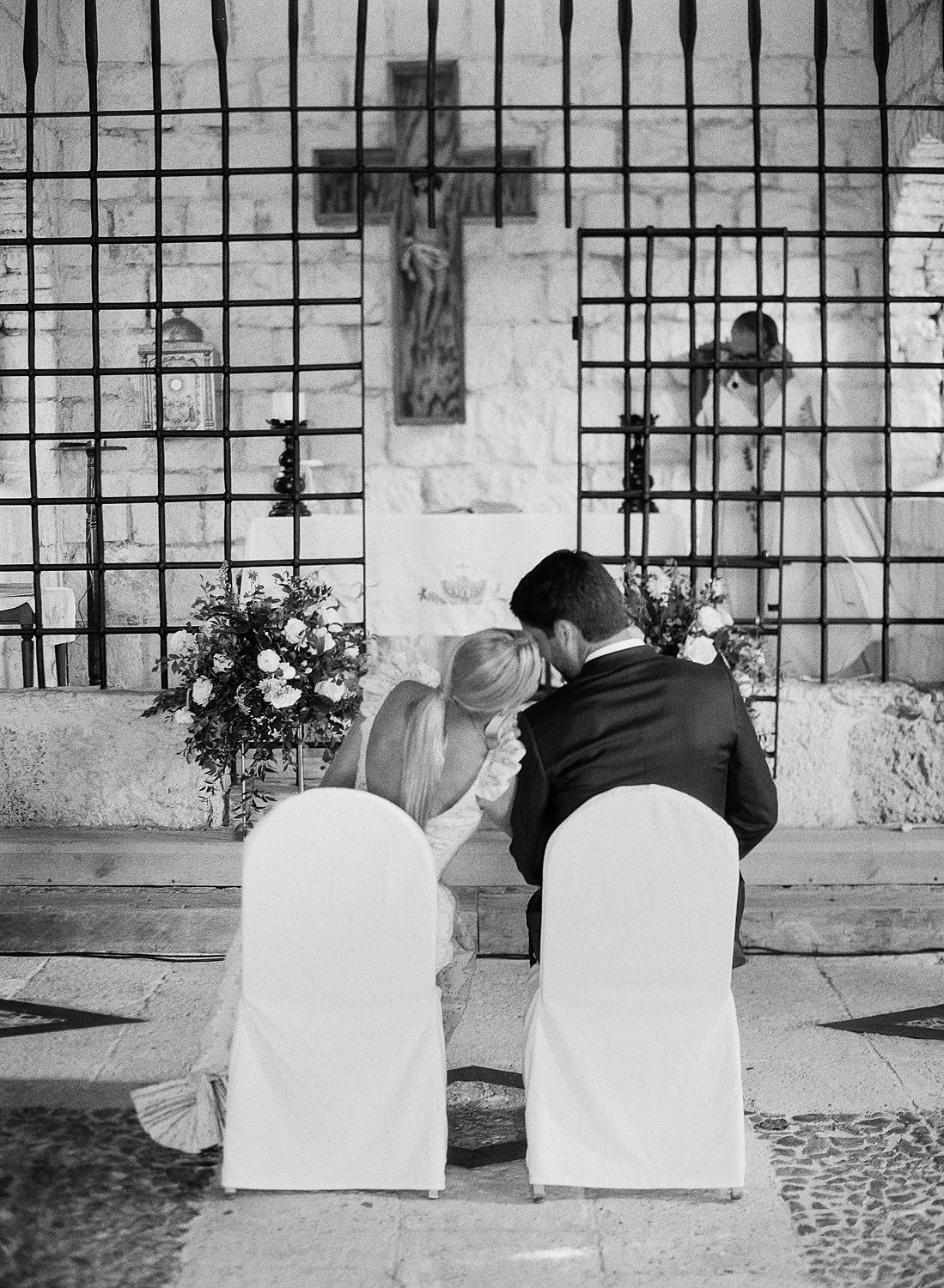 Bride and groom sitting and chatting together during private family ceremony at Altos De Chavon.