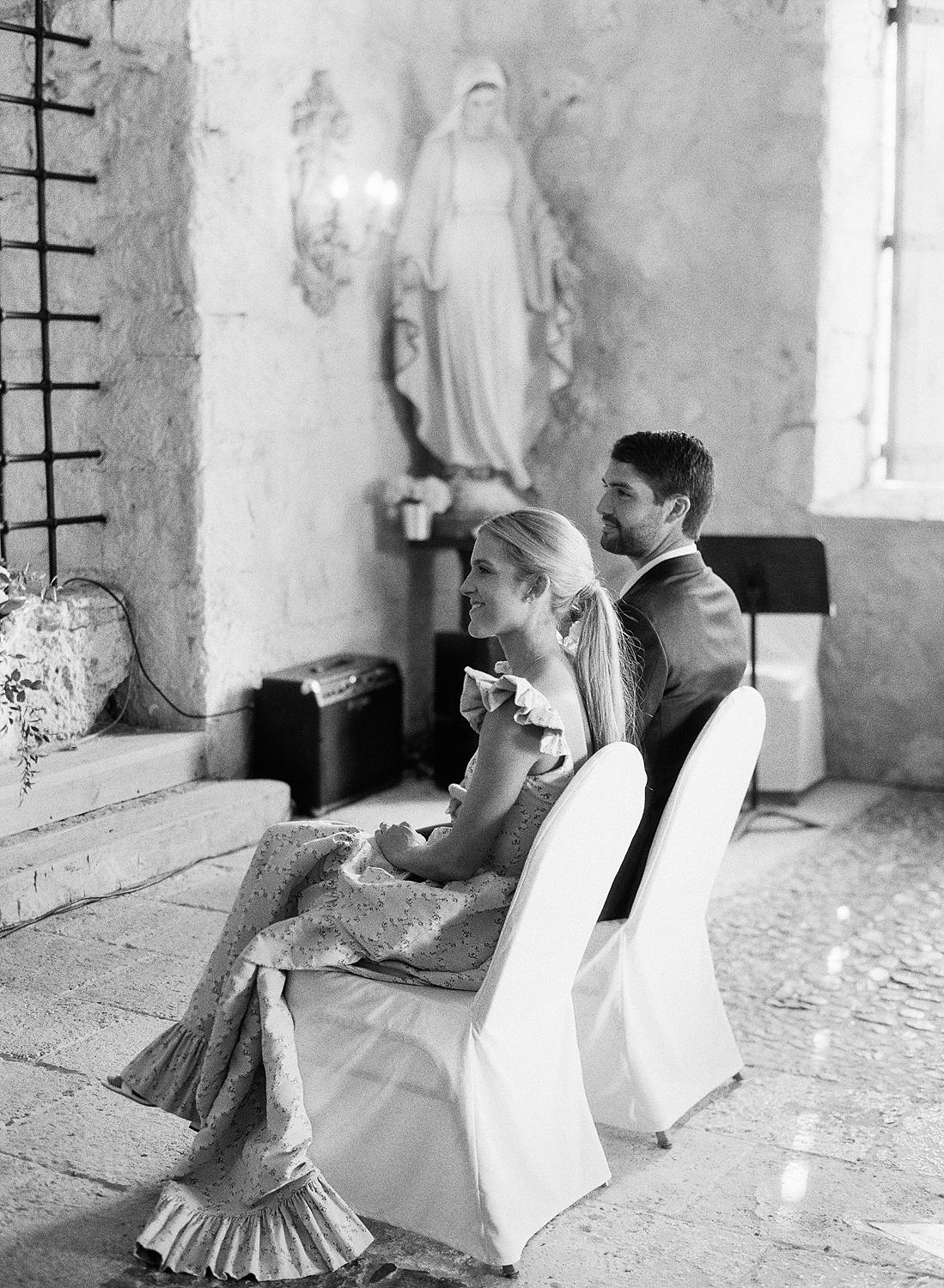 Bride and groom watching speaker at their private family ceremony at Altos De Chavon.