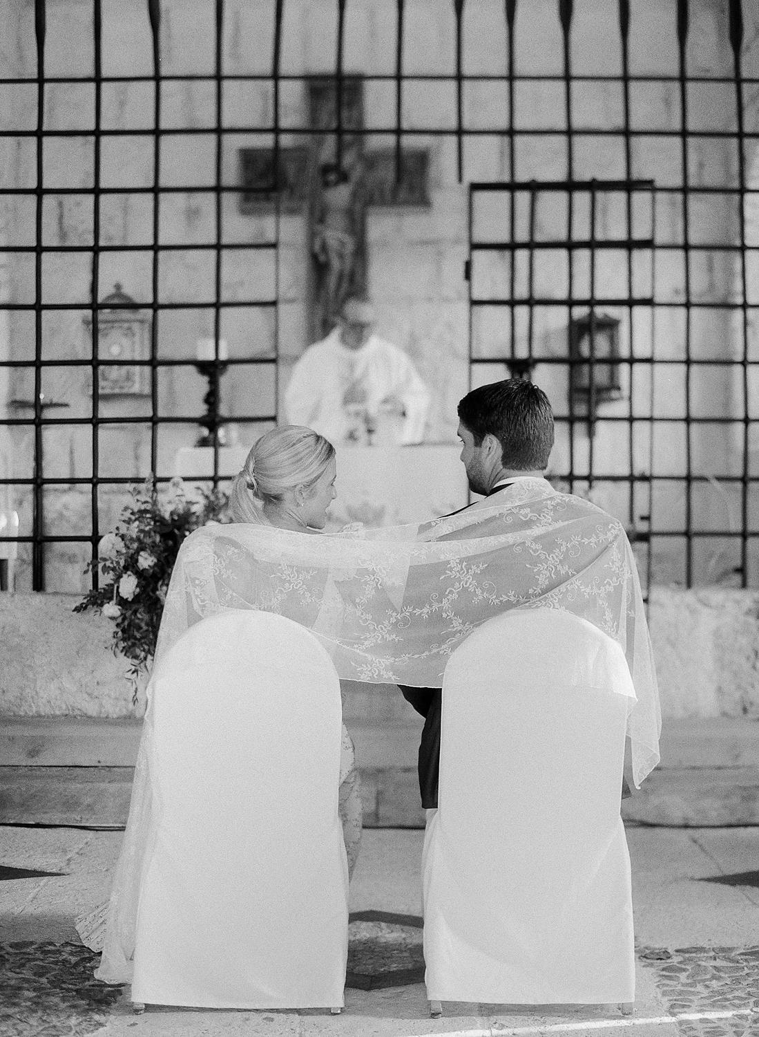 Bride and groom sitting after being wrapped together during their private family ceremony at Altos De Chavon.