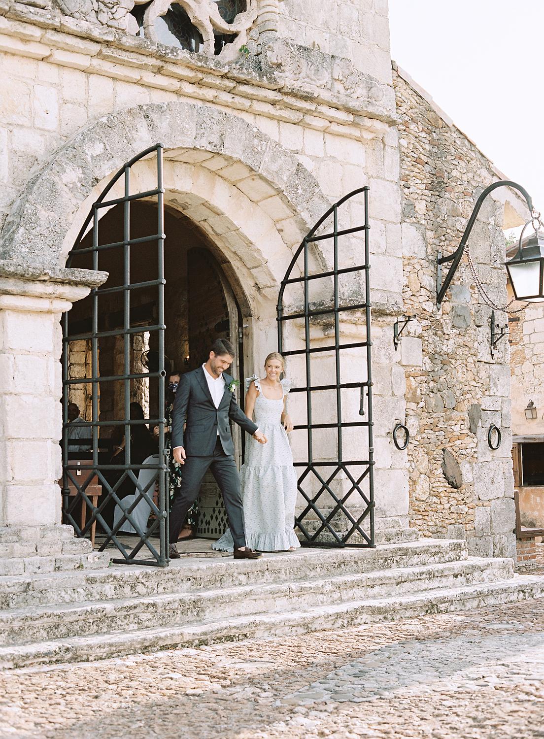 Bride and groom walking out of the church as husband and wife after private family ceremony at altos de chevon.