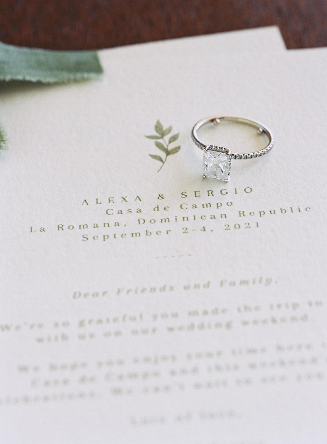 Bride's engagement ring on wedding invitation for Altos de Chavón wedding.