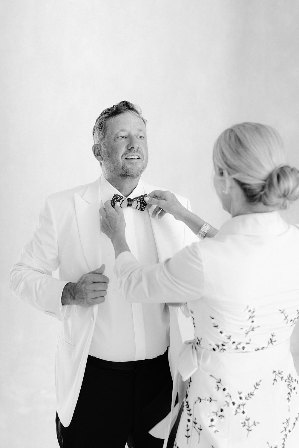 Father of bride getting help with his bow tie before seeing his daughter for the first time at Altos de Chavon wedding.