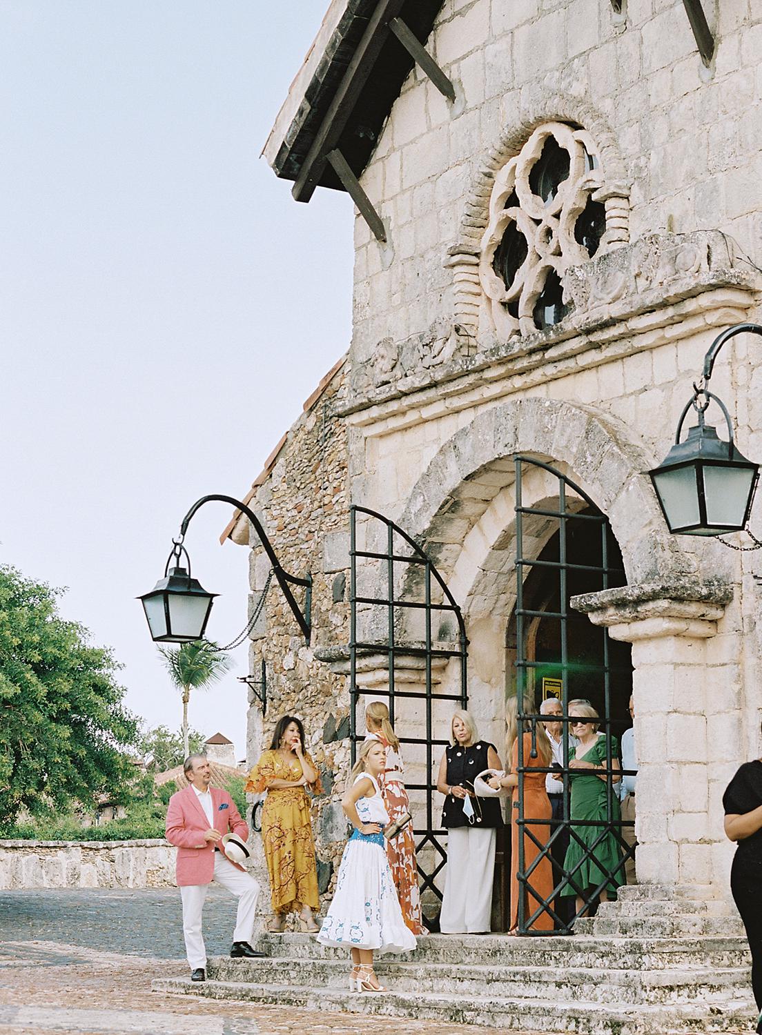 Guests waiting for wedding ceremony to begin at the church in Altos De Chavon