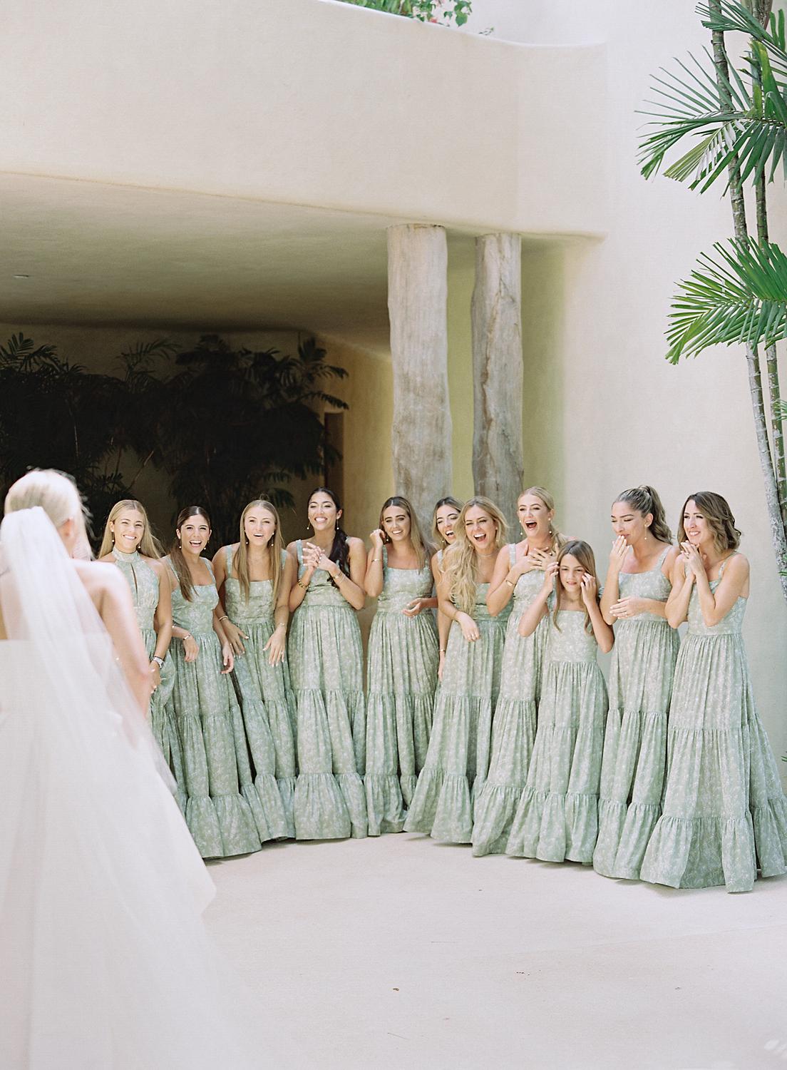 Bride showing bridesmaids her dress for the first time during their Altos de Chavón wedding.