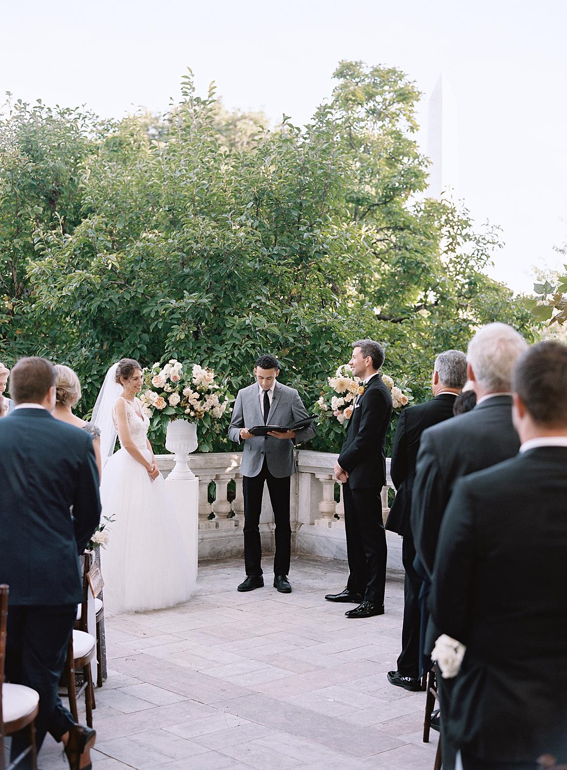 Bride and groom at the alter during there ceremony at DAR Constitutional Hall.