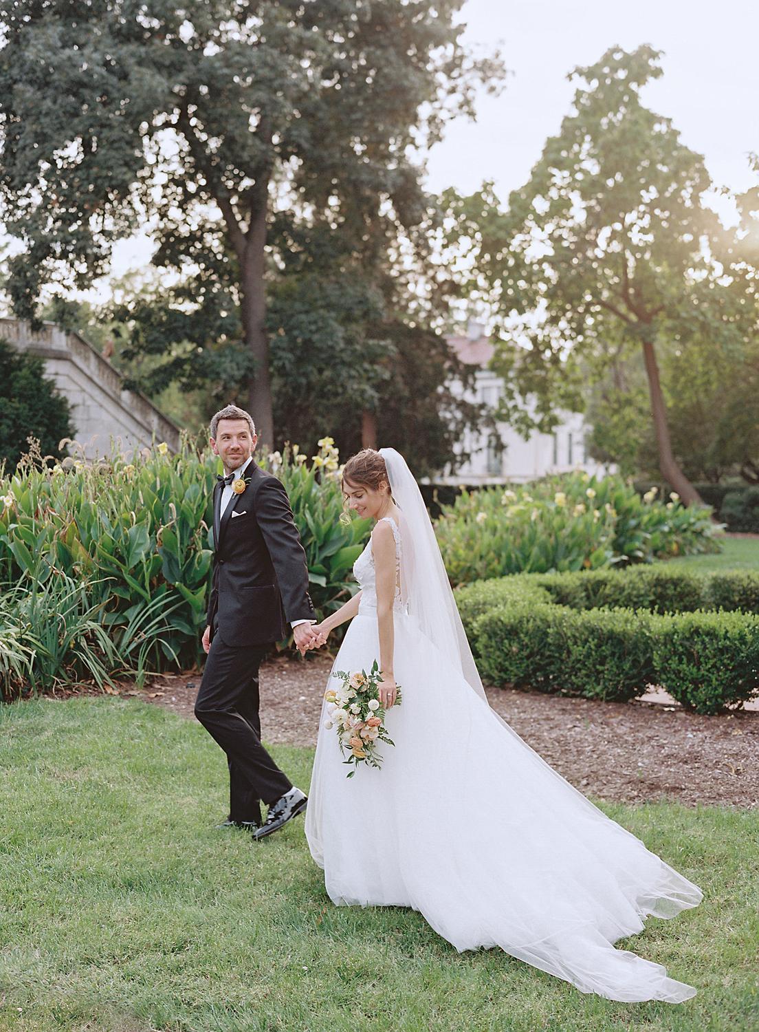 Bride and groom walking together during golden hour at their DAR Constitution Hall wedding.