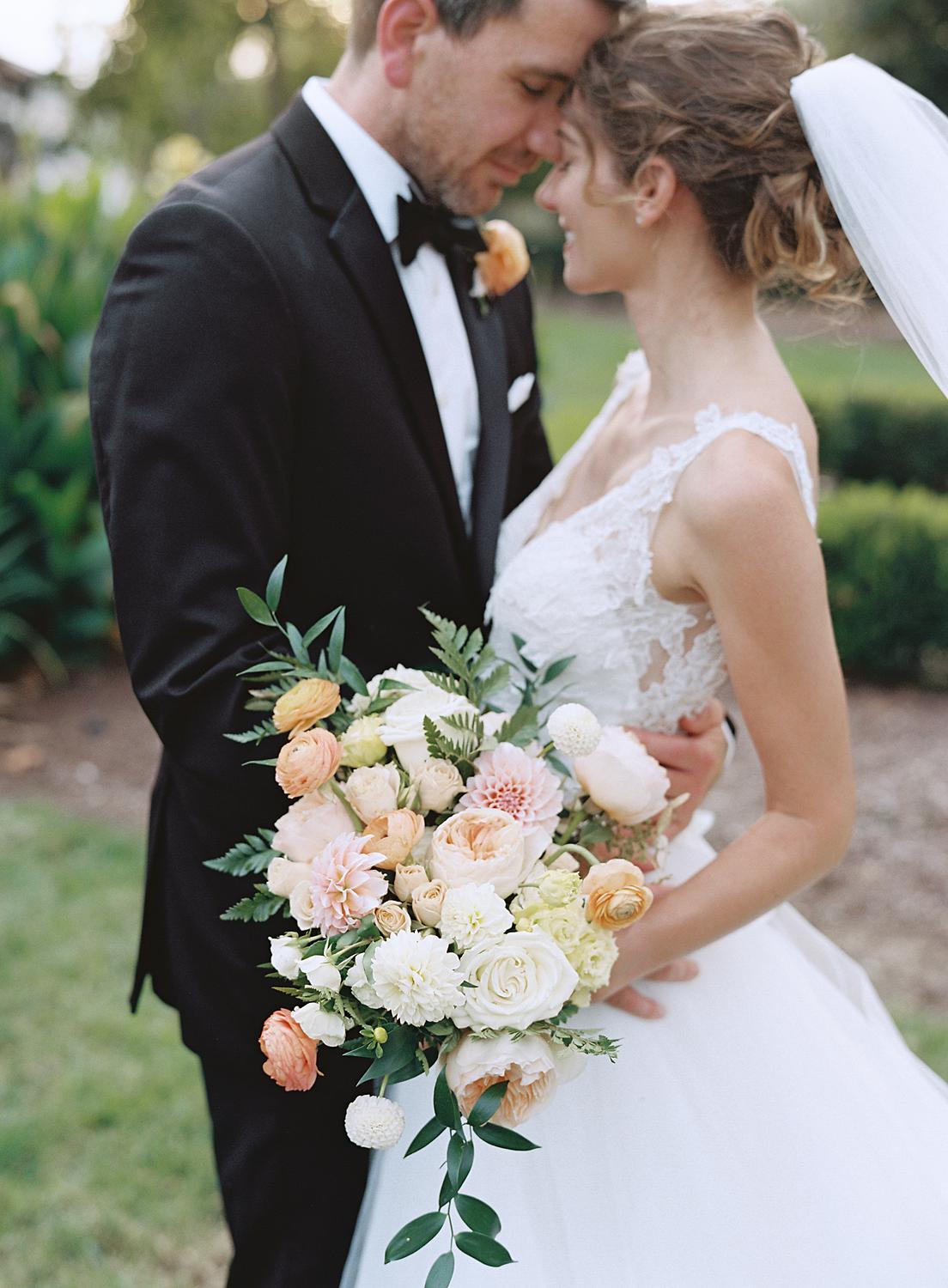 Bride and groom embracing during the cocktail hour of their DAR Constitution Hall wedding.